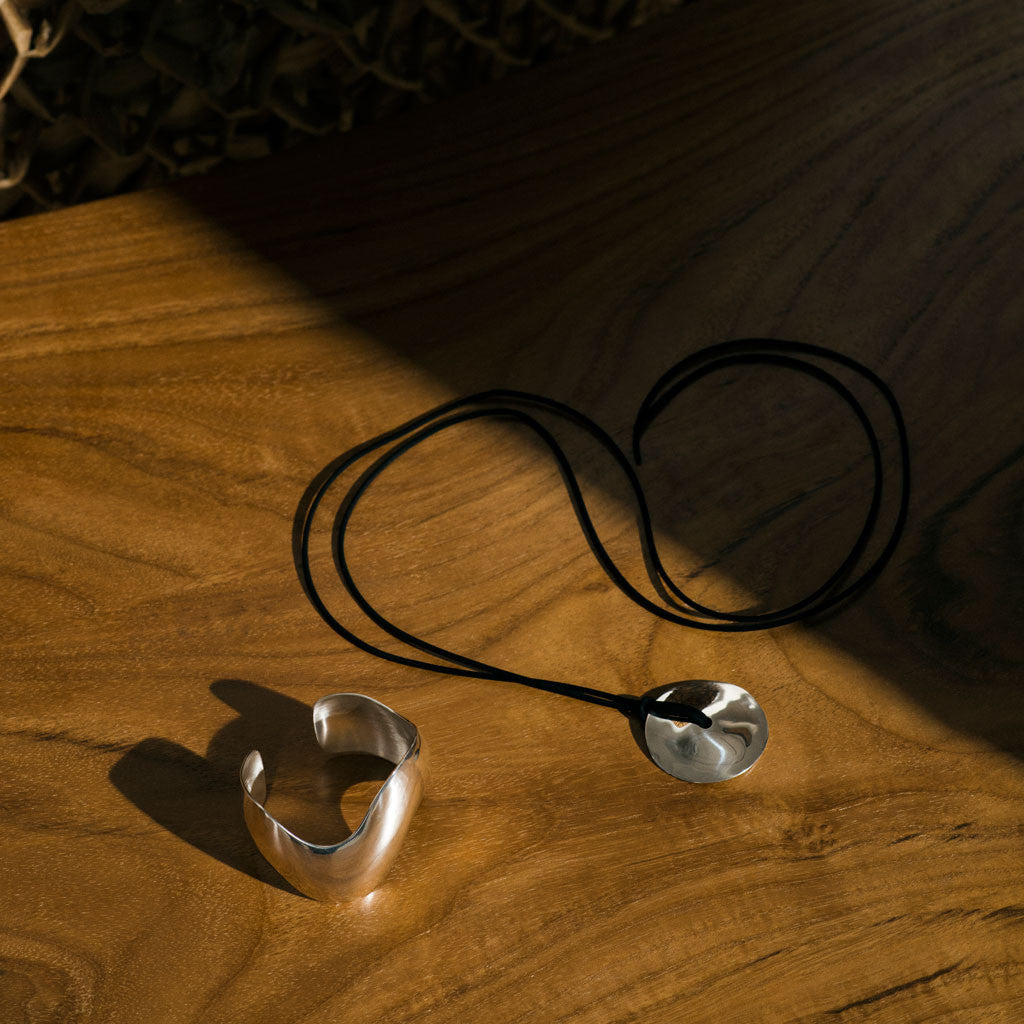 AGMES 0.925 Sterling Silver Cora Pendant paired with Black Suede Cord. Round Pendant Necklace. Sculpted Claudia Cuff