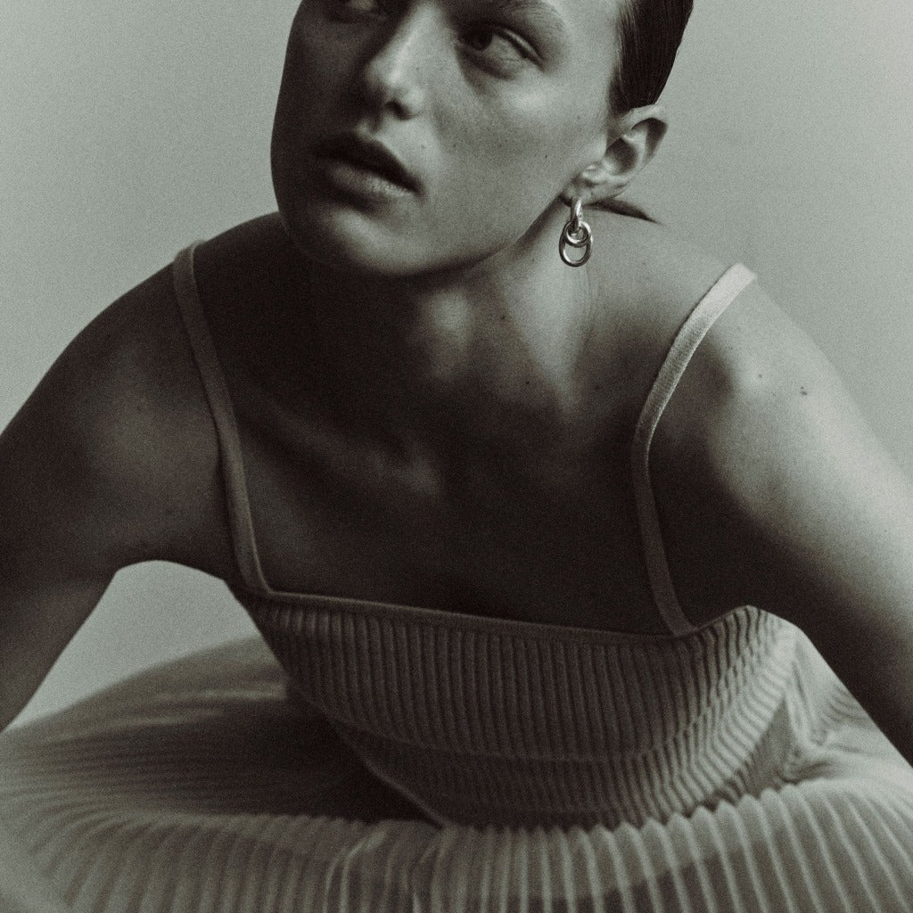 Woman wearing AGMES 0.925 sterling silver double drop hoop earrings.