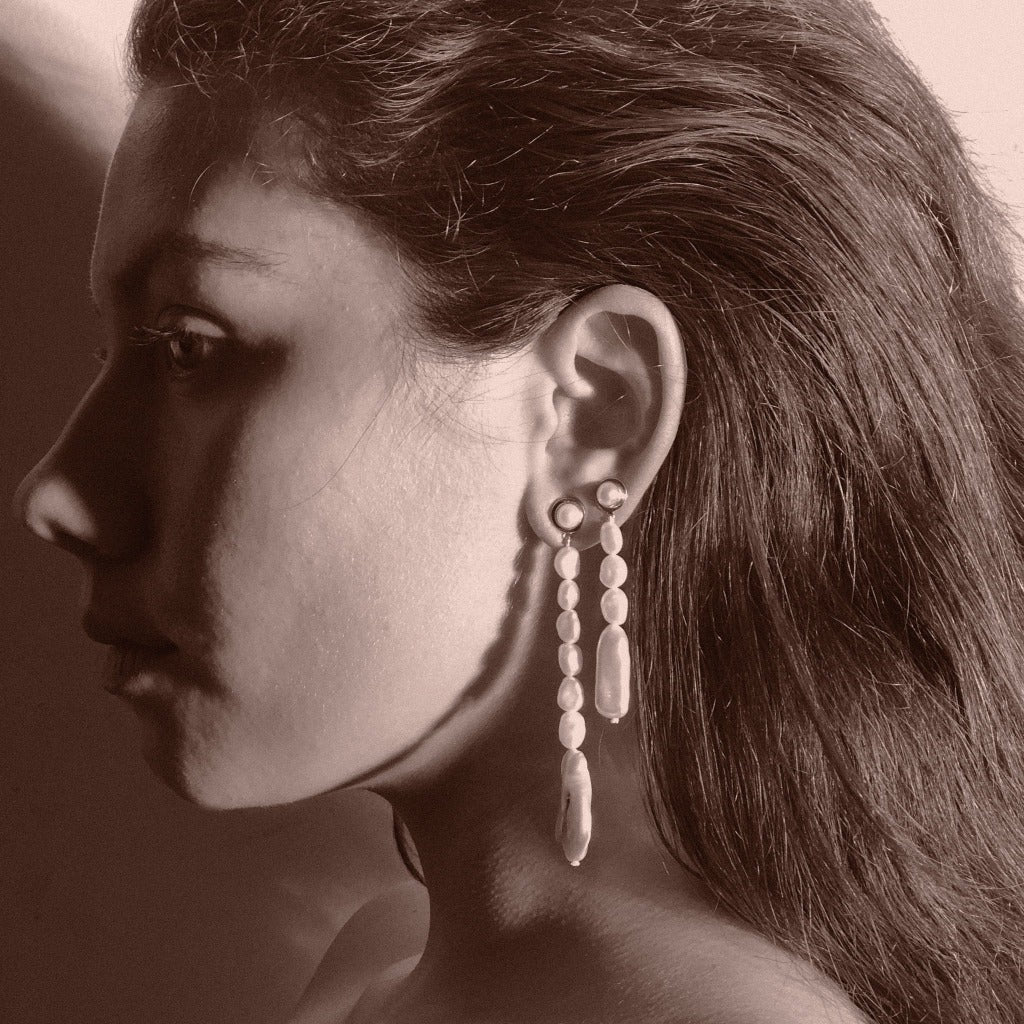 Woman wearing AGMES pearl drop earrings 0.925 sterling silver