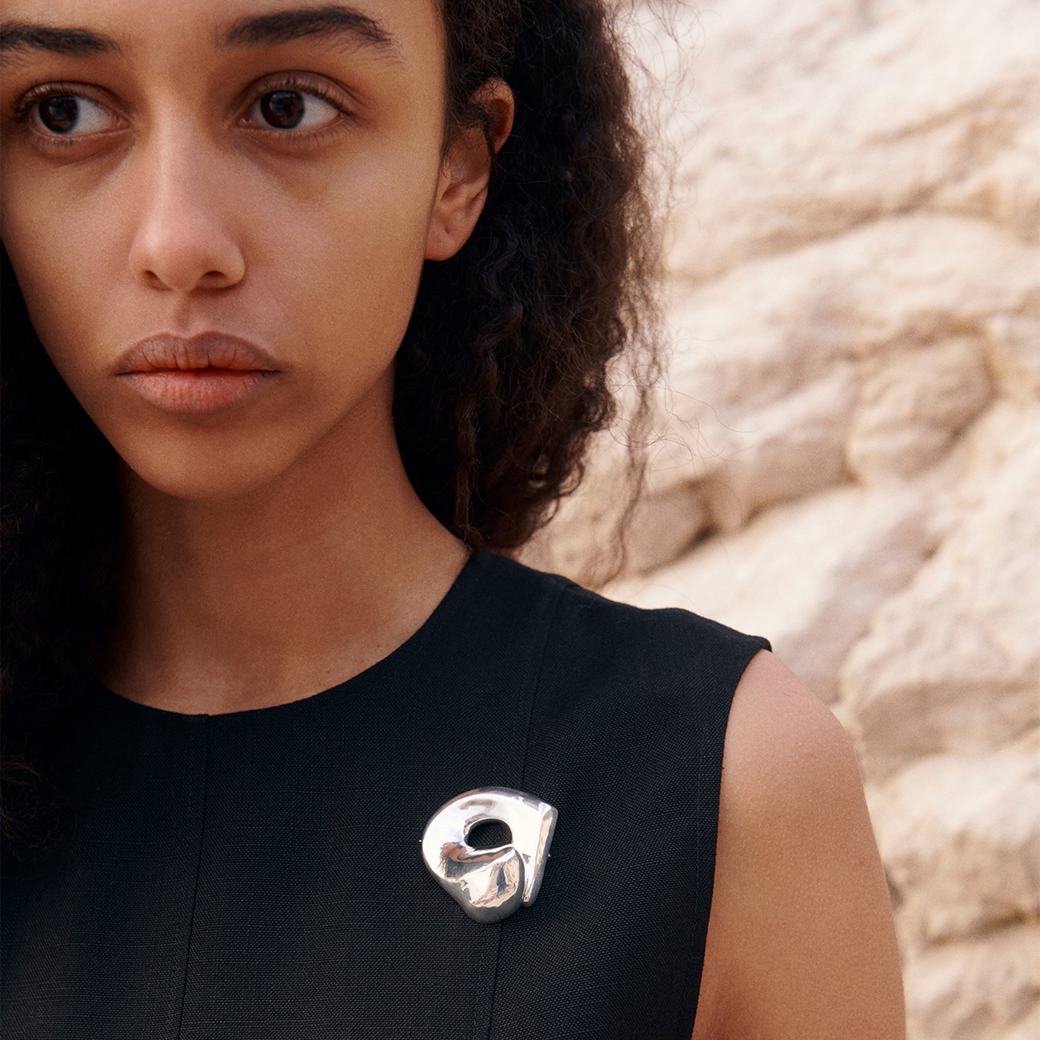 Woman wearing AGMES .925 Sterling Silver Gertrude Brooch on black dress. Simone Bodmer-Turner.
