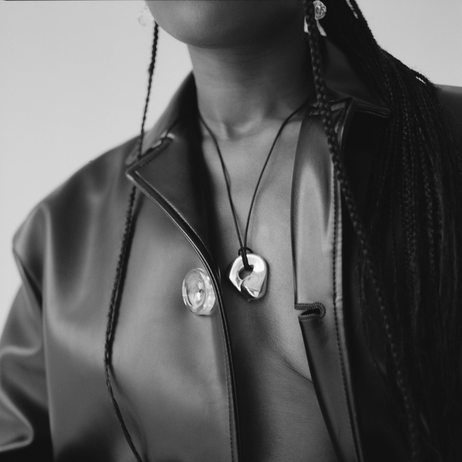 Woman wearing AGMES .925 Sterling Silver Structural Gertrude Pendant with Black Suede Cord. Simone Bodmer-Turner.
