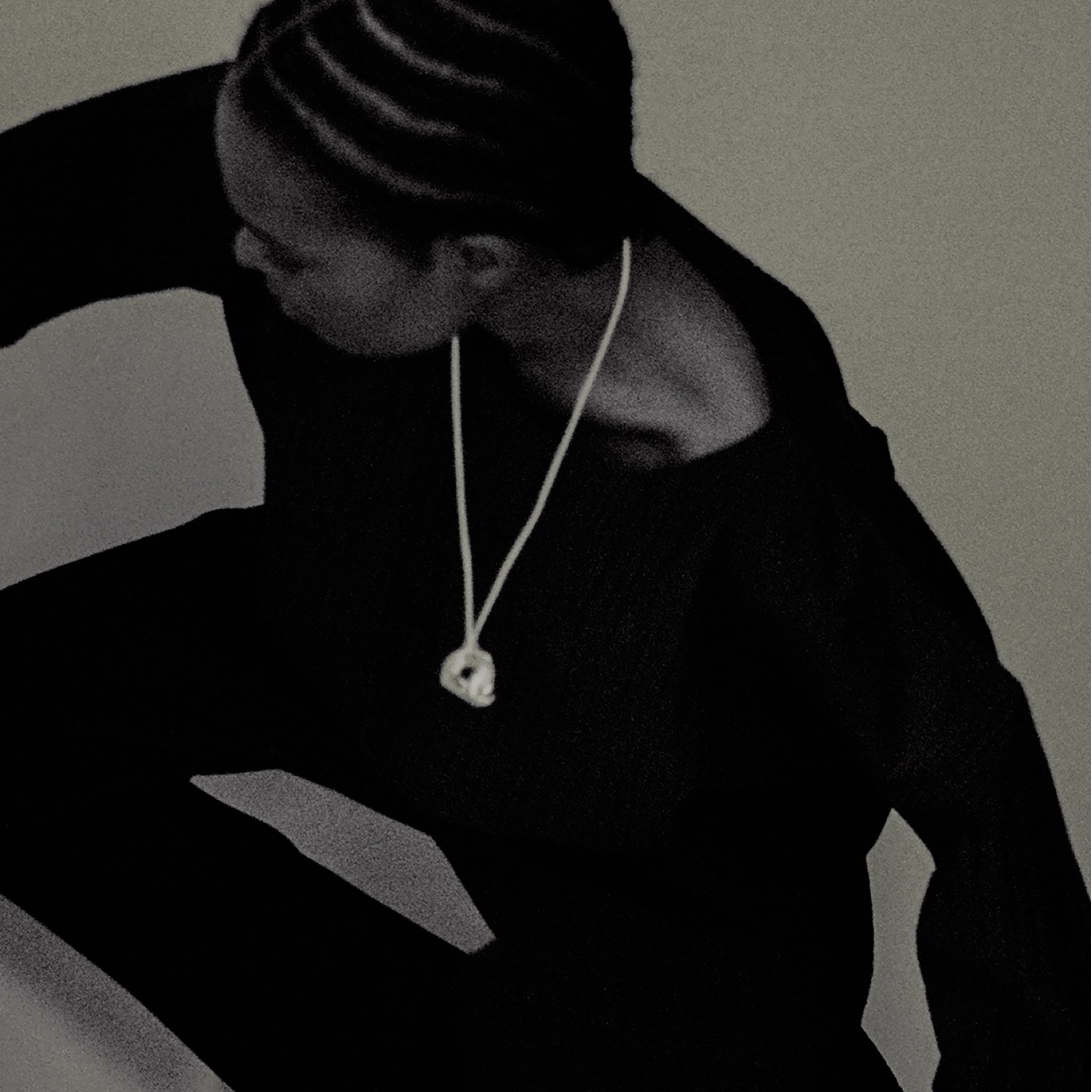 Person wearing AGMES .925 Sterling Silver Structural Gertrude Pendant with Ivory Satin Cord. Simone Bodmer-Turner.