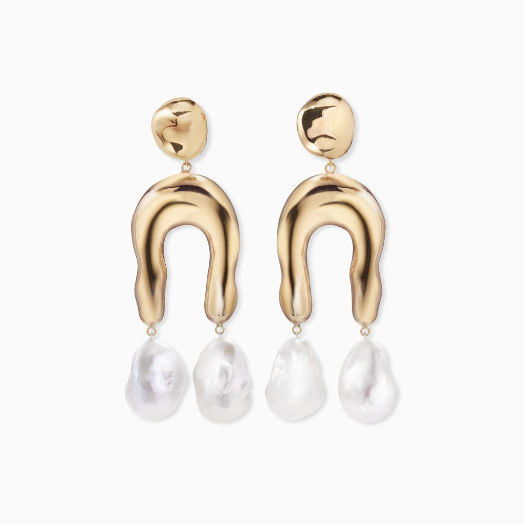 AGMES 18k gold vermeil earrings with sculpted wishbone and freshwater pearl drop on white background.