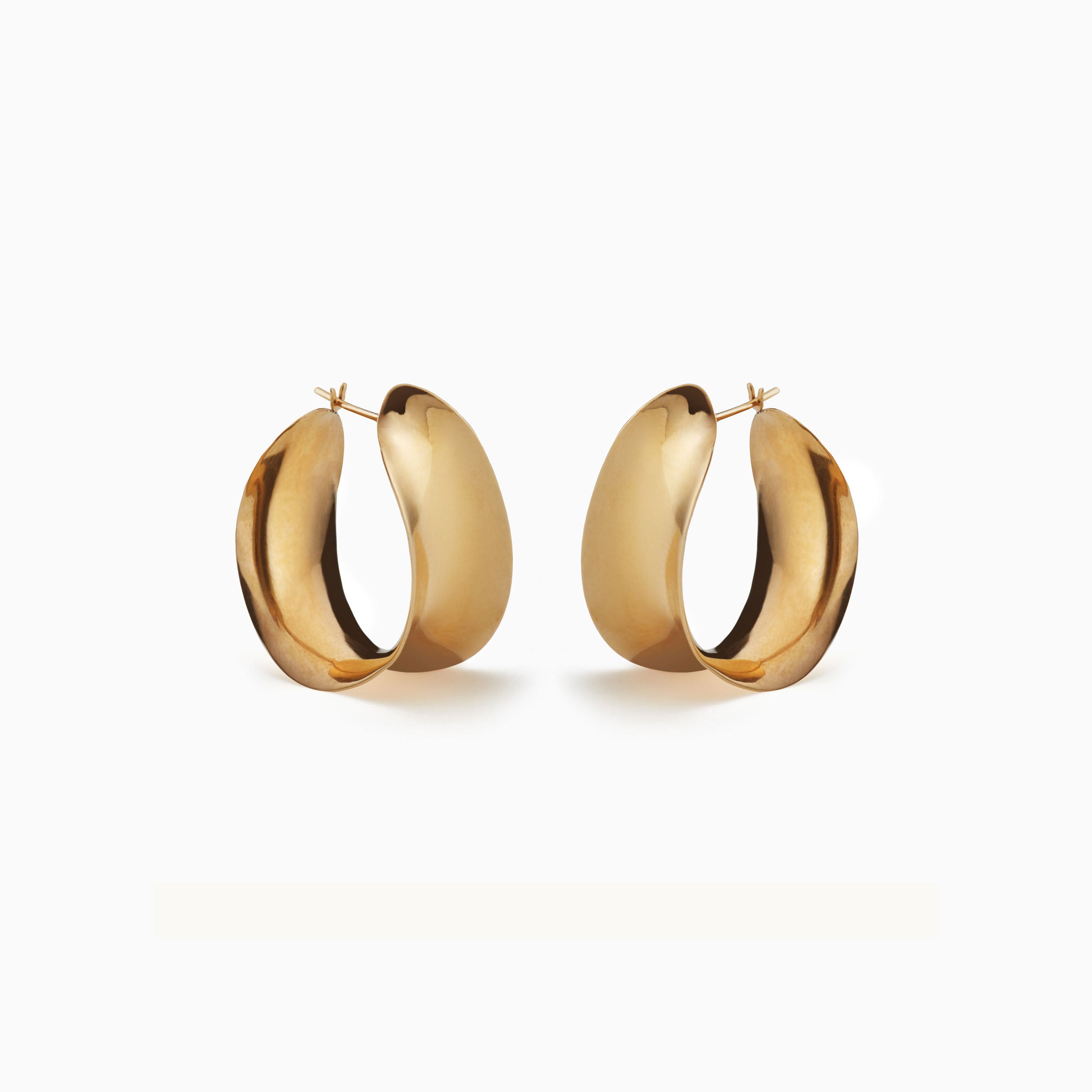 AGMES 18k gold vermeil Laila twist hoop earrings on white background.