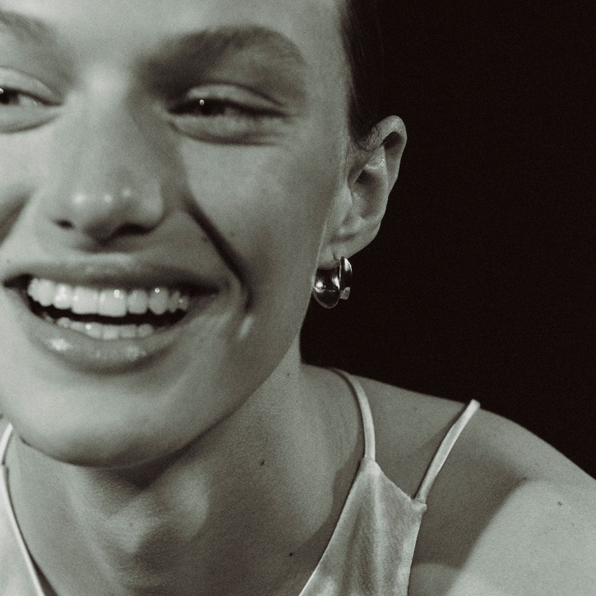 Woman wearing AGMES 18k gold vermeil mini twist hoop earrings.