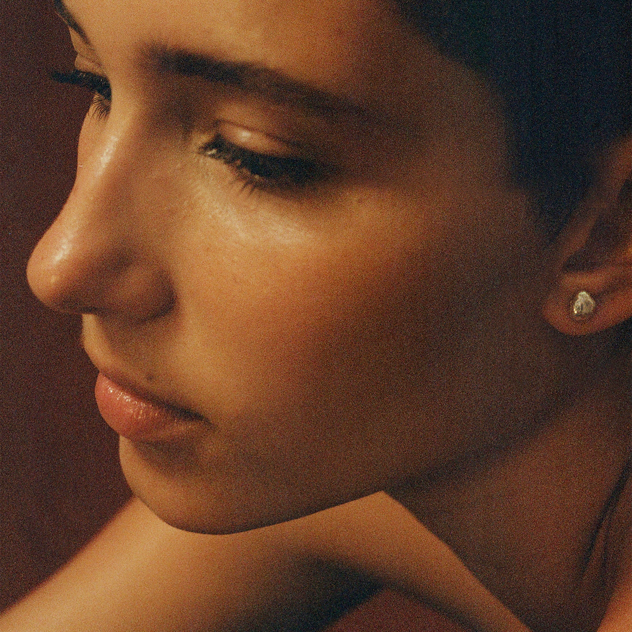 Person wearing AGMES pearl stud earrings.