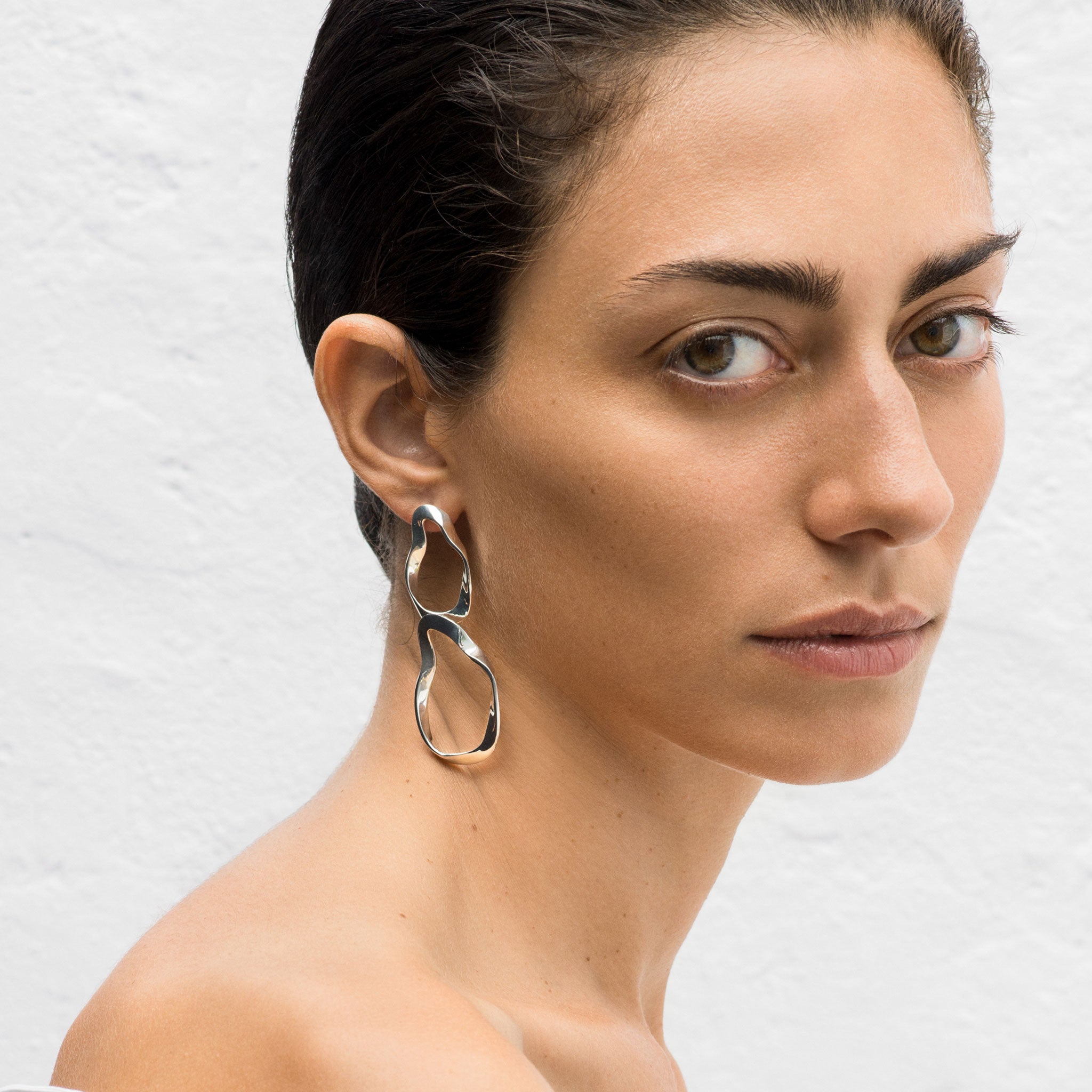 Woman wearing .925 sterling silver AGMES earrings with 2-tiered hoop design.