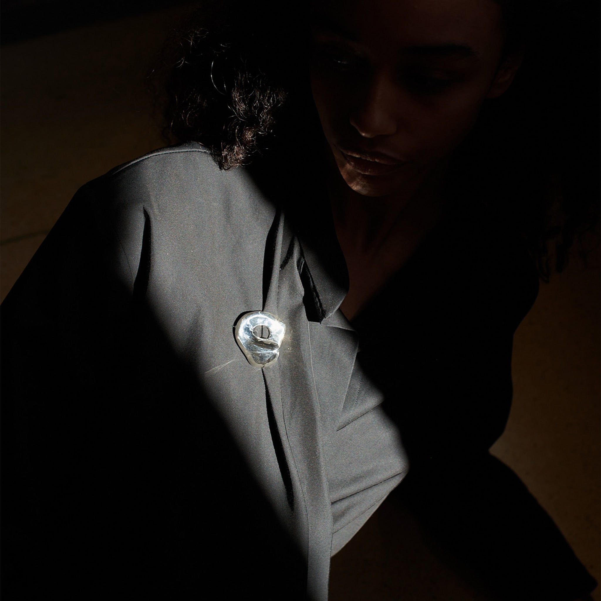 Person wearing AGMES .925 Sterling Silver Gertrude Brooch on grey blazer. Simone Bodmer-Turner.