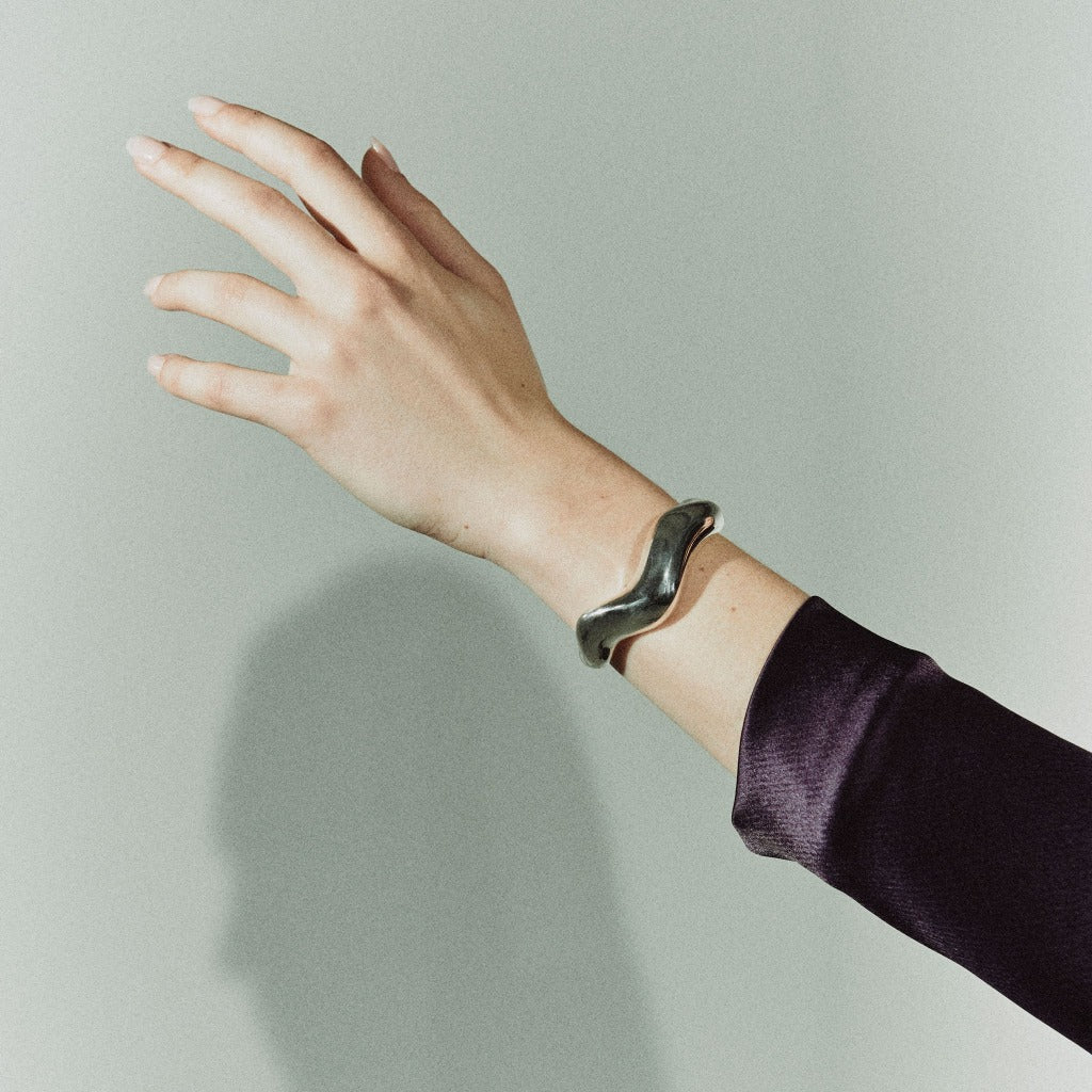 Person wearing AGMES 0.925 sterling silver large Astrid sculpted cuff bracelet.
