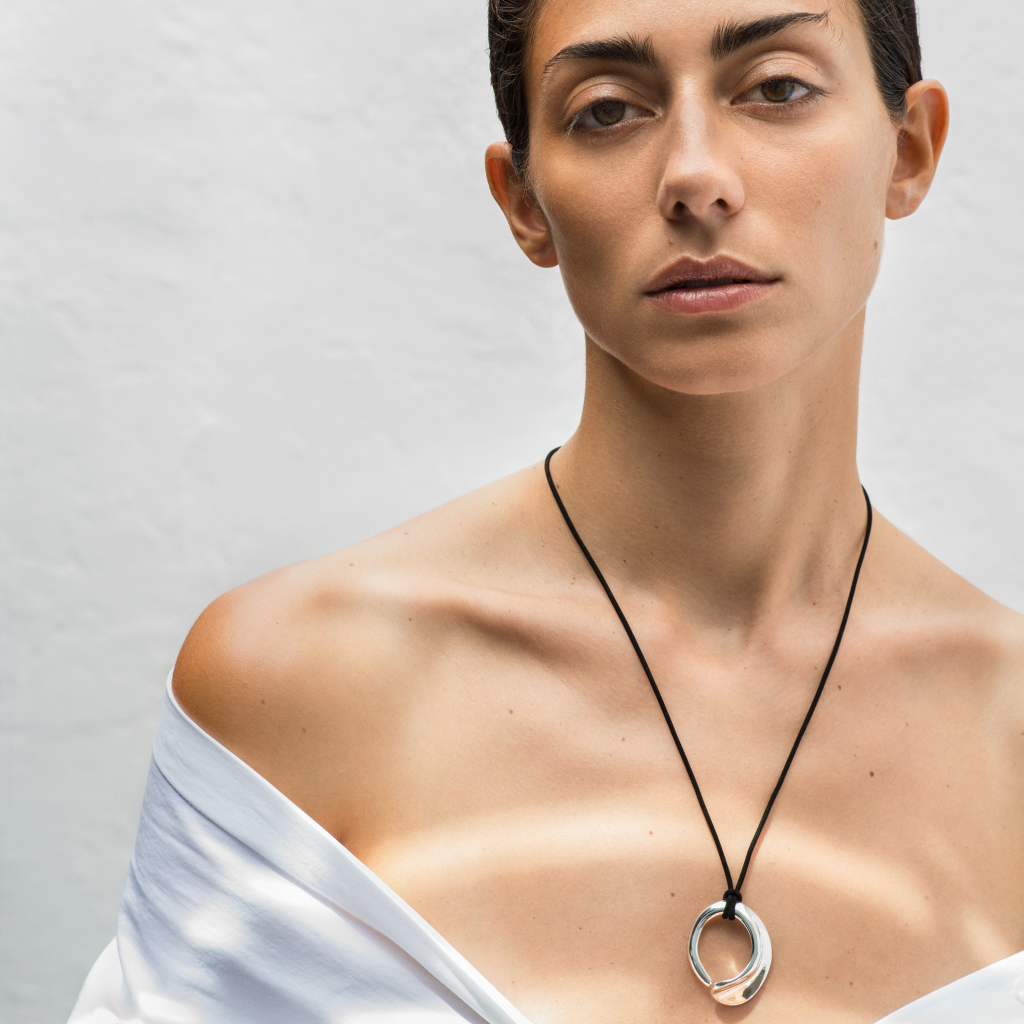 Woman wearing AGMES 0.925 Sterling Silver Marta Pendant with Black Suede Cord.