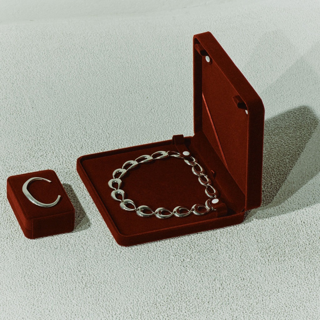 AGMES 0.925 sterling silver small thin sculpted cuff bracelet and round linked Tilda necklace in red suede boxes.