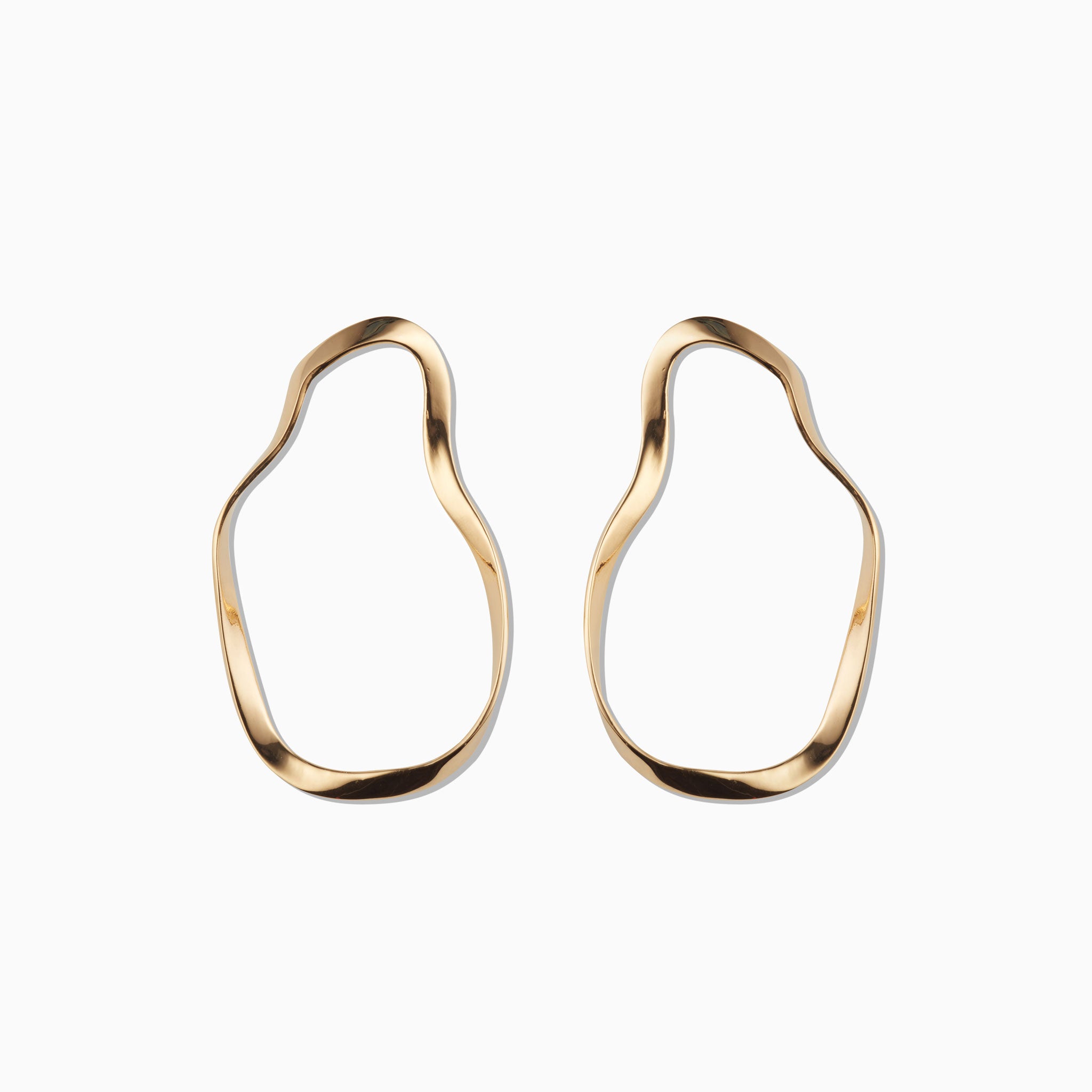 AGMES 18k gold vermeil sculptural wavy round hoop earrings.
