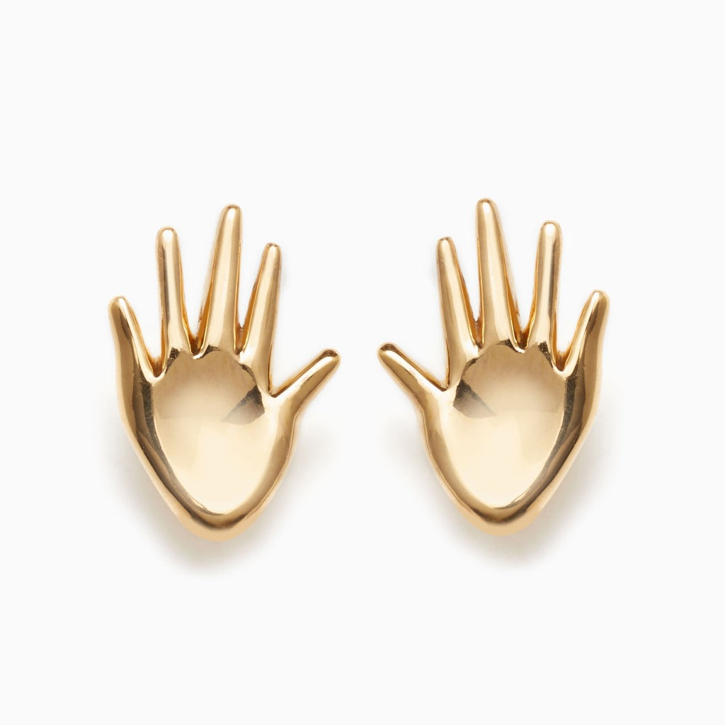 AGMES 18k gold vermeil abstract hand Dali earrings on white background.
