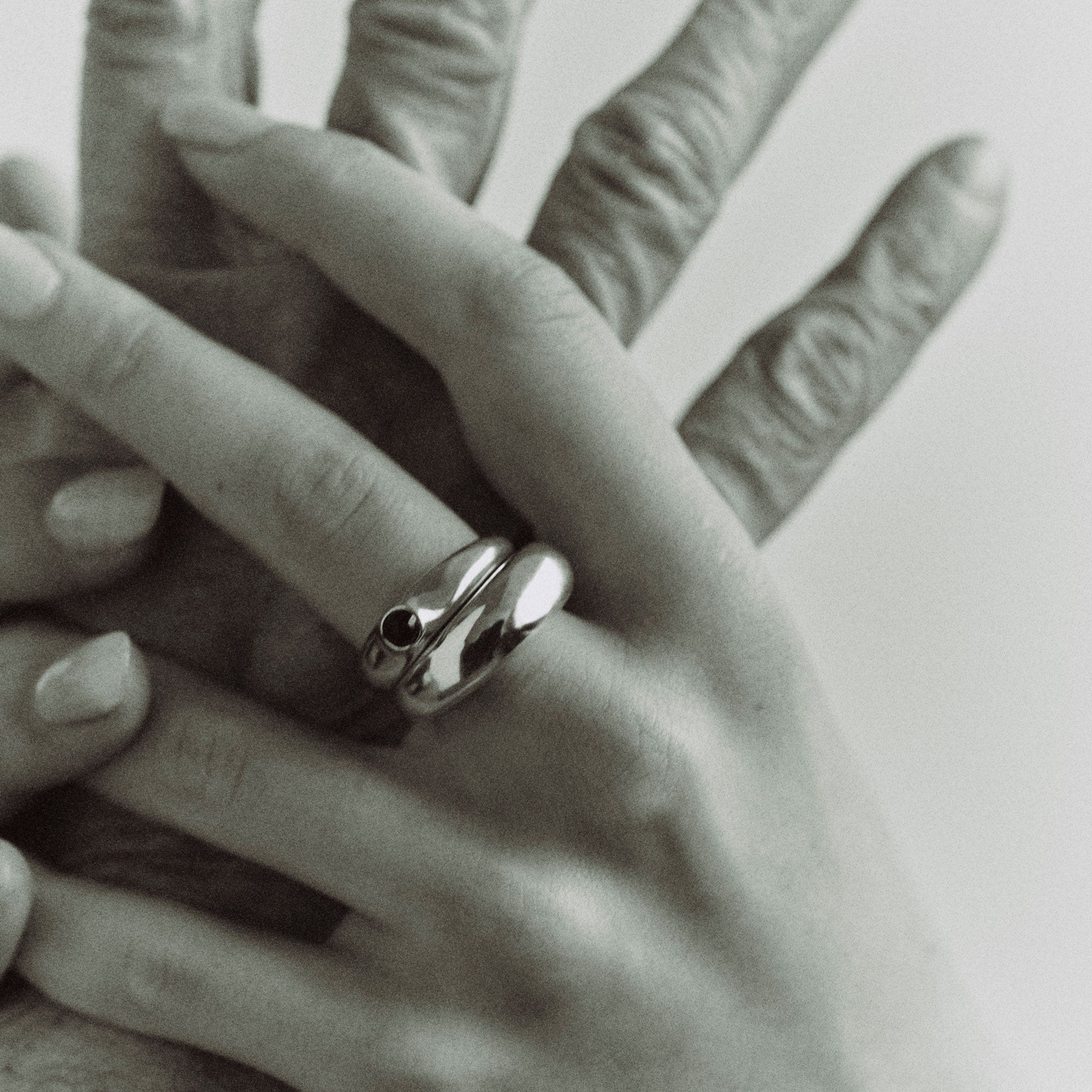 AGMES .925 Sterling Silver Cara Ring with Onyx Stone center paired with Domed Ring.