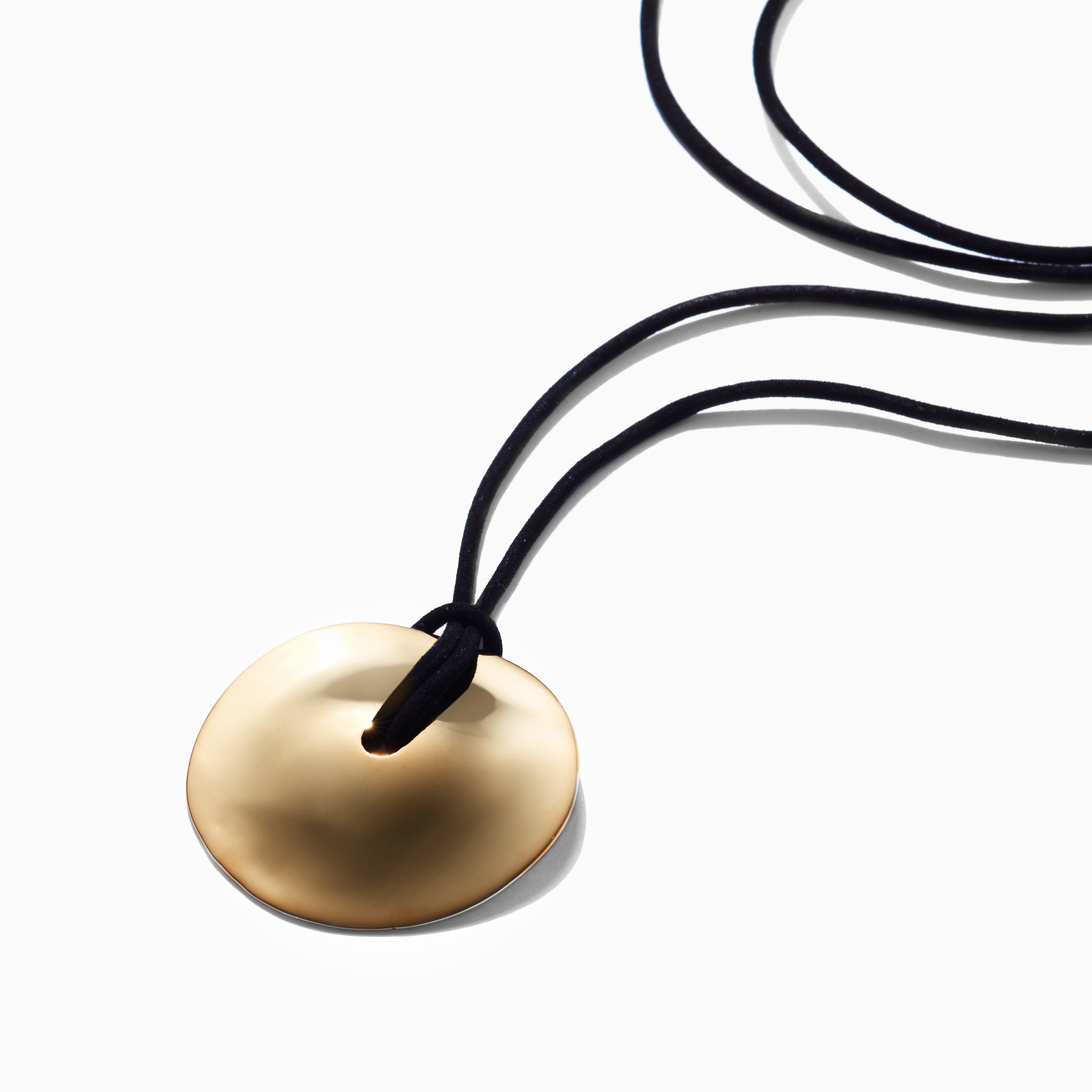 AGMES 18K Gold Vermeil Cora Pendant paired with Black Suede Cord. Round Pendant Necklace on white background.