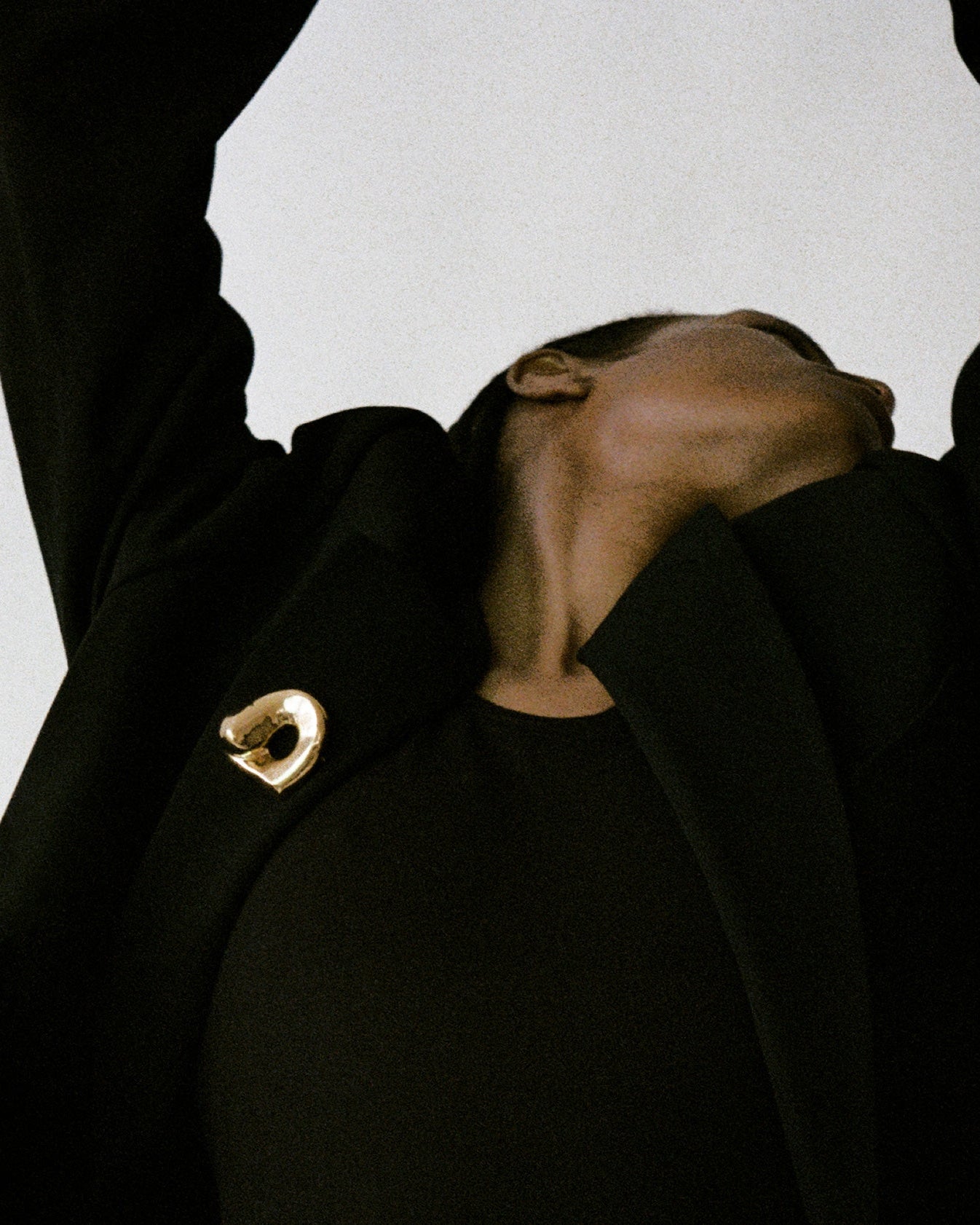 Woman wearing AGMES 18K Gold Vermeil Gertrude Brooch on black blazer. Simone Bodmer-Turner.