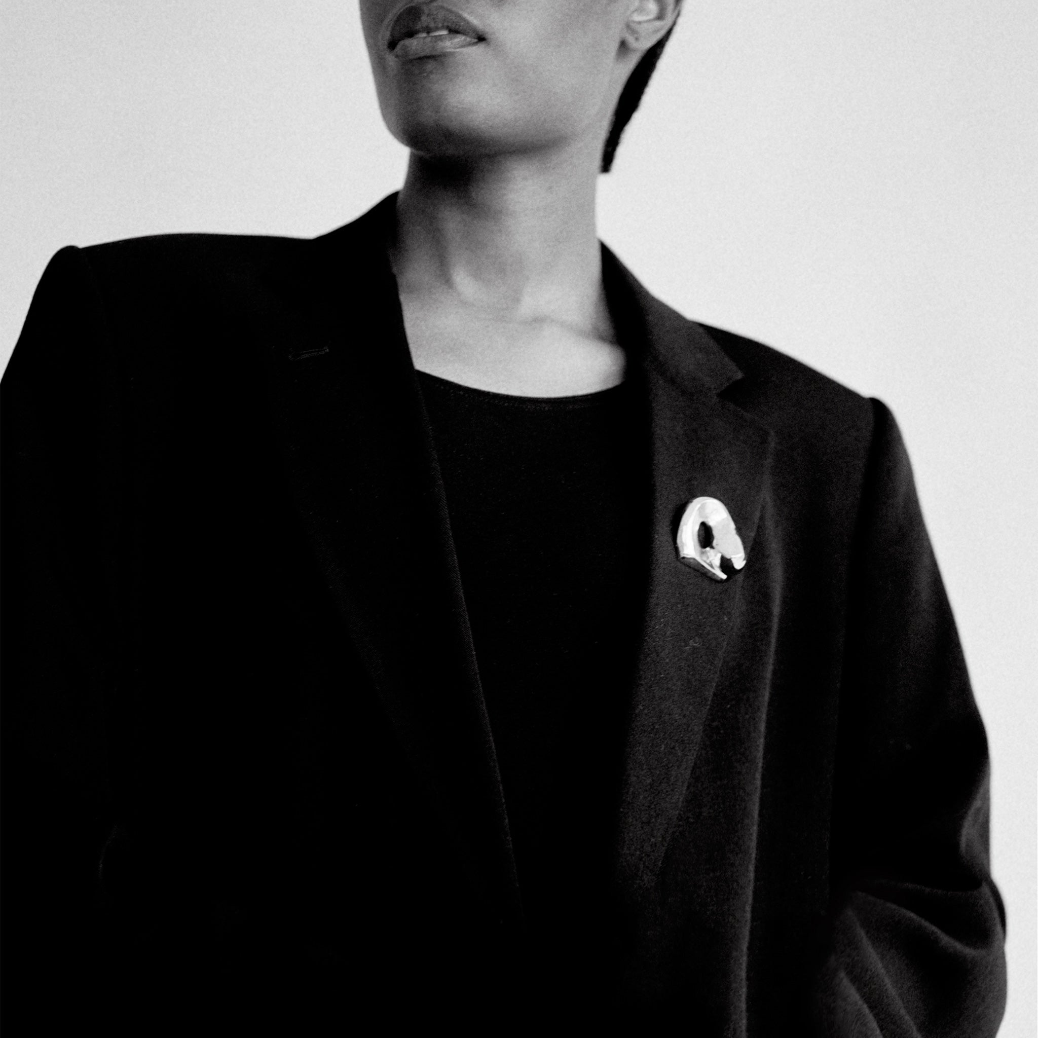 Person wearing AGMES .925 Sterling Silver Gertrude Brooch on black blazer. Simone Bodmer-Turner.