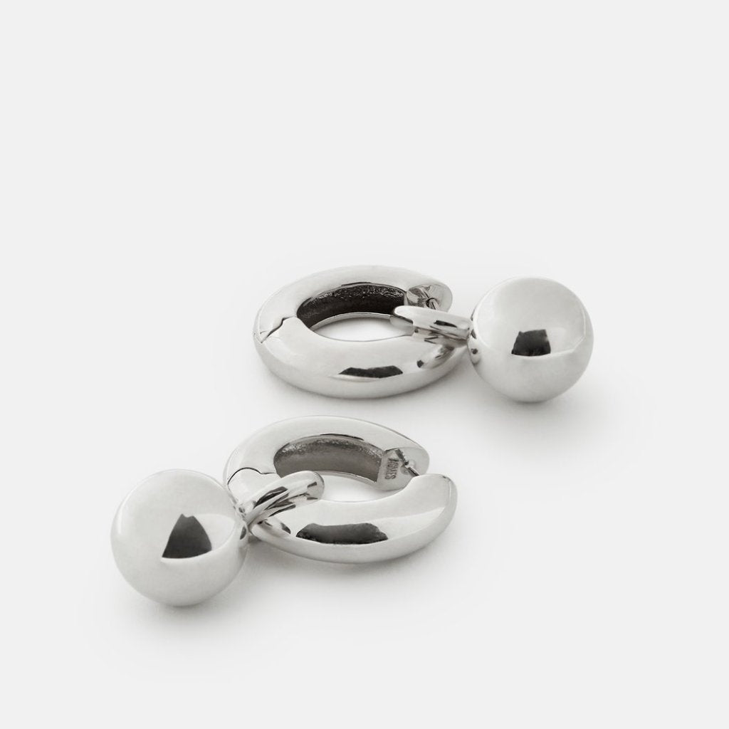 AGMES 0.925 sterling silver hinged hoop earrings with round embellishments.