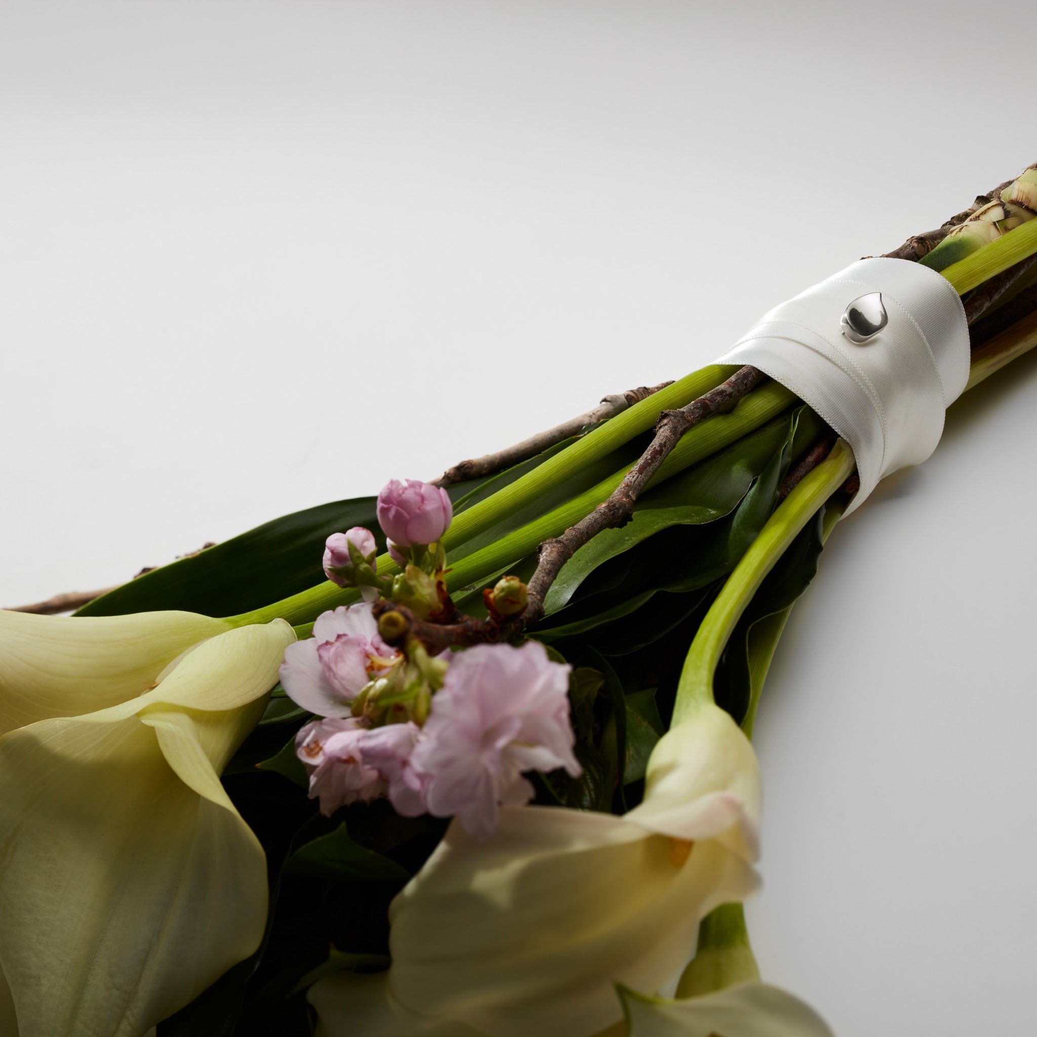 AGMES .925 Sterling Silver Sum of Parts Mini Brooch displayed on bouquet.