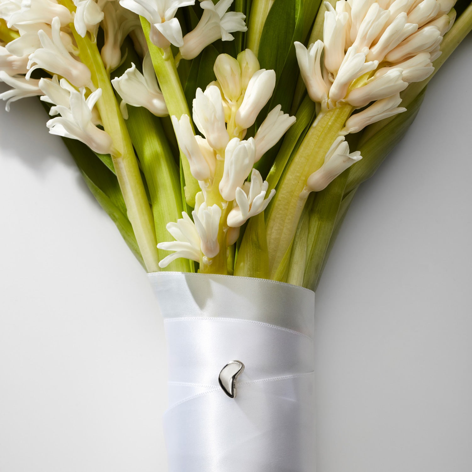 AGMES .925 Sterling Silver Sum of Parts Mini Brooch displayed on bouquet.