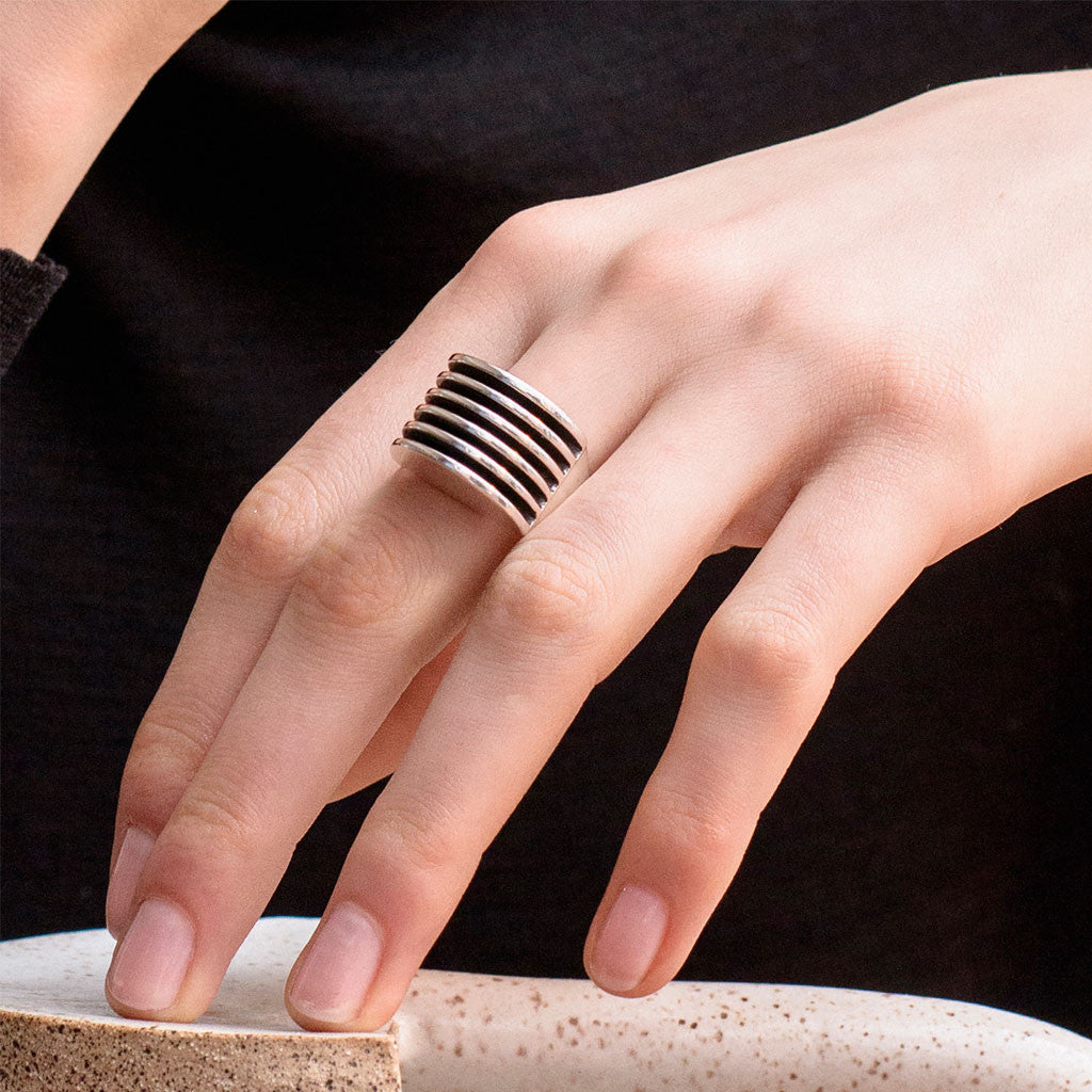 Hand wearing AGMES .925 Sterling Silver Wide Boeri Ring.