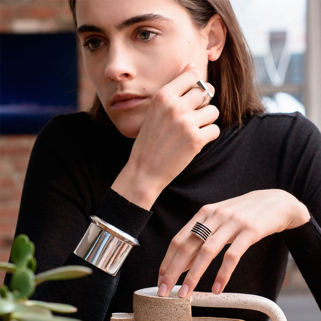 Woman wearing AGMES .925 Sterling Silver Wide Boeri Ring and Cliff Cuff.