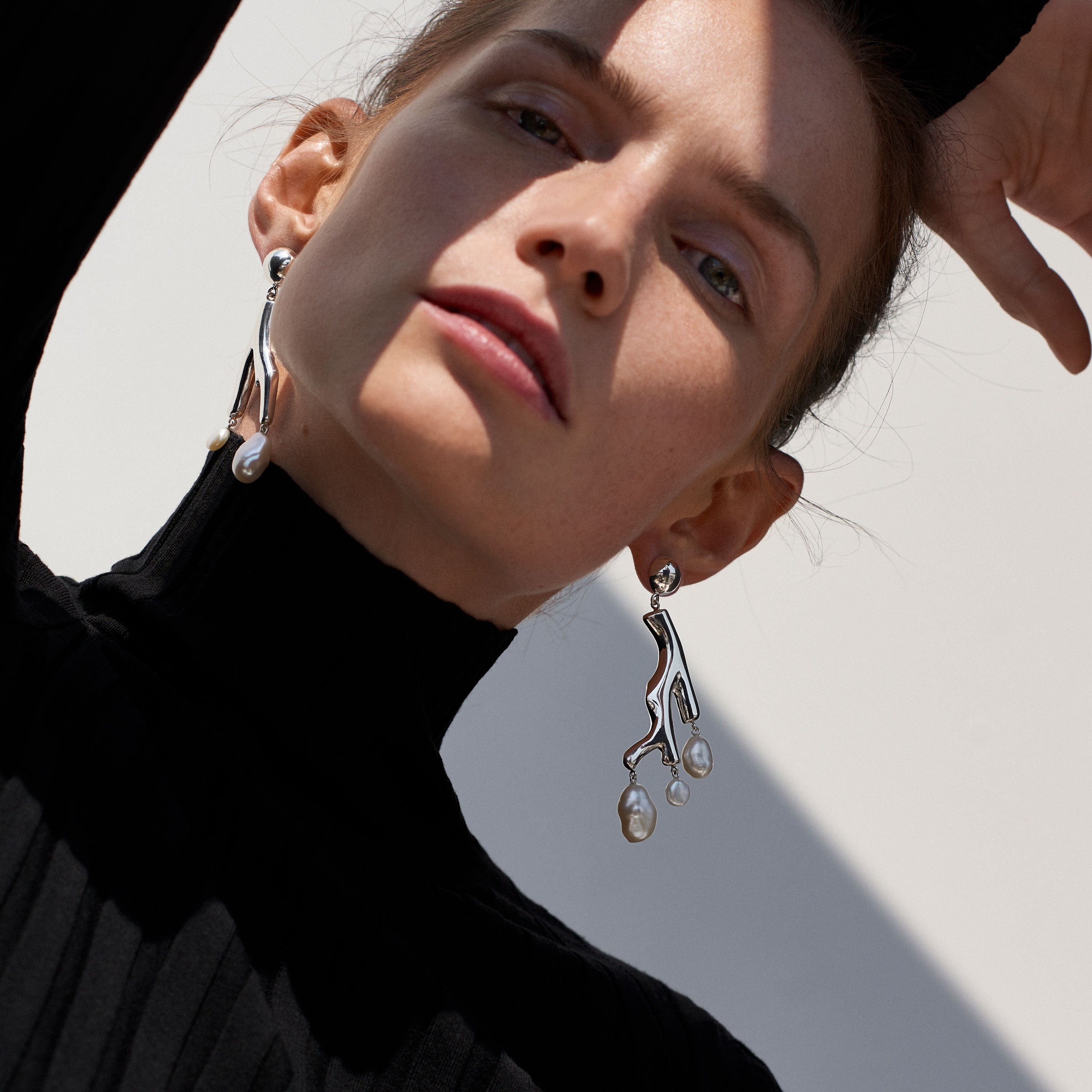 Woman wearing AGMES 0.925 sterling silver coral drop earrings with baroque pearls.