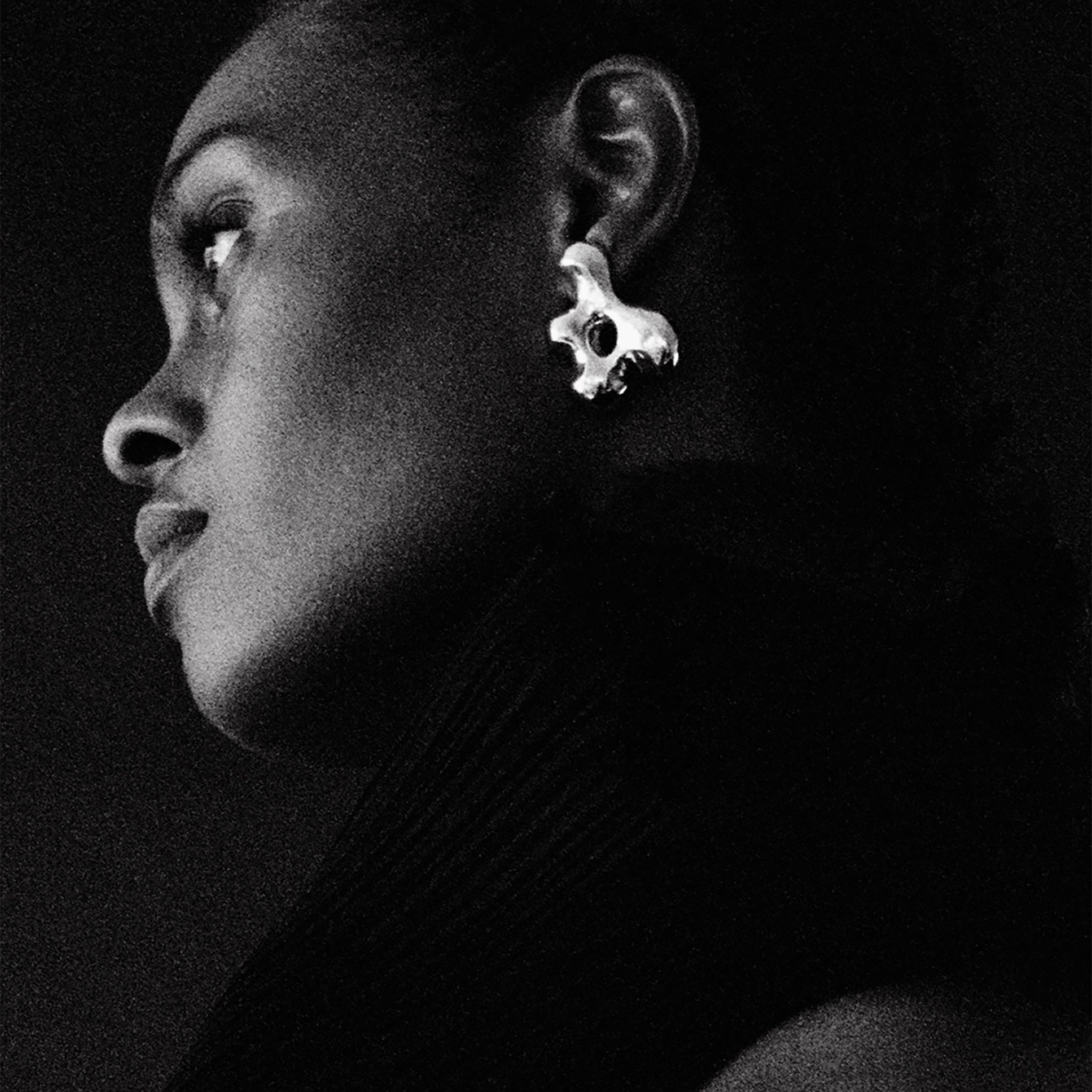 Woman wearing AGMES 0.925 sterling silver sculpted earrings. Simone Bodmer-Turner.