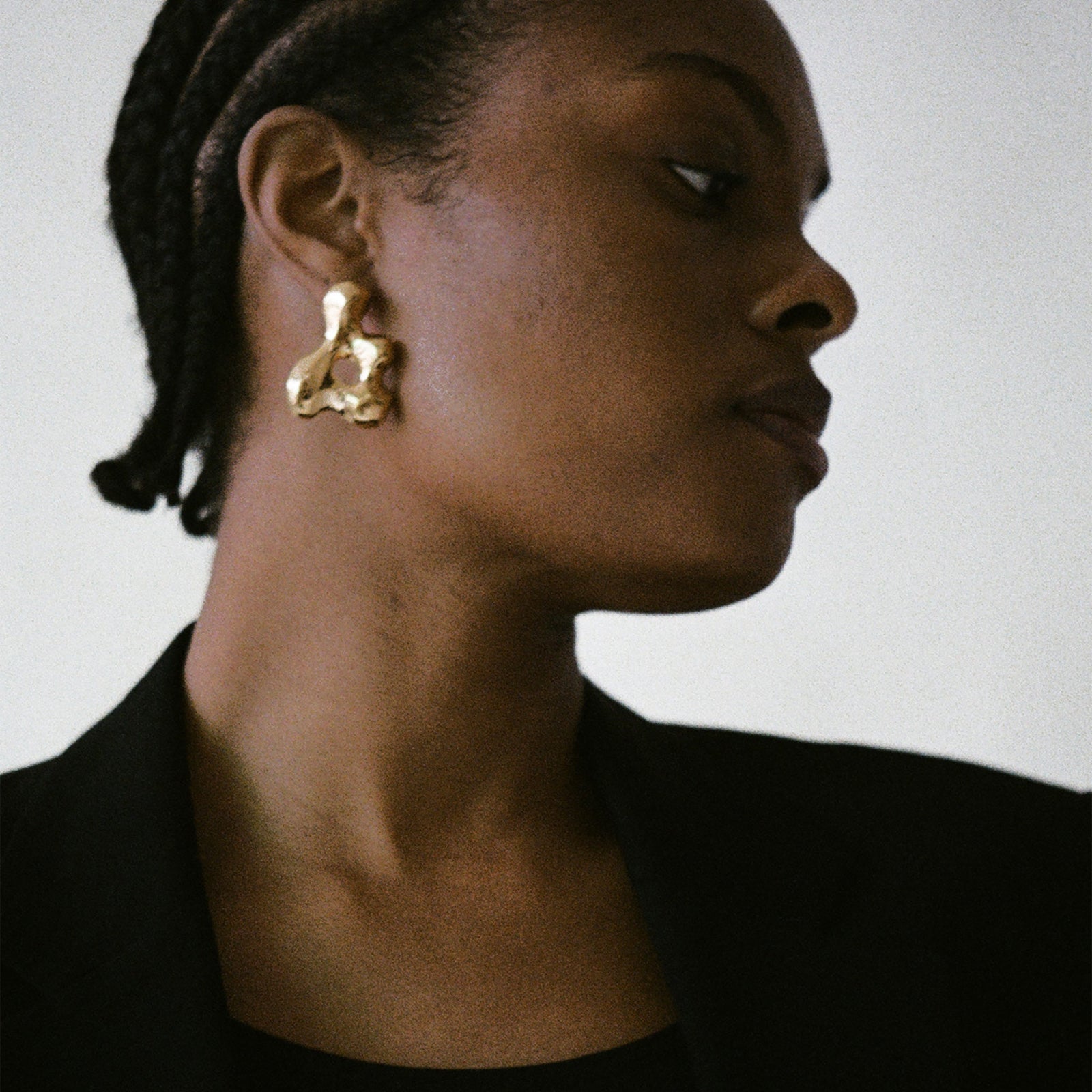 Woman wearing AGMES 18k gold vermeil sculpted earrings. Simone Bodmer-Turner.