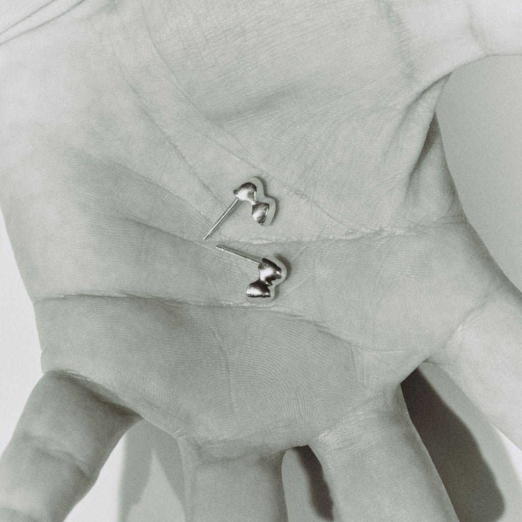 AGMES 0.925 sterling silver sculpted bubble stud earrings in hand.