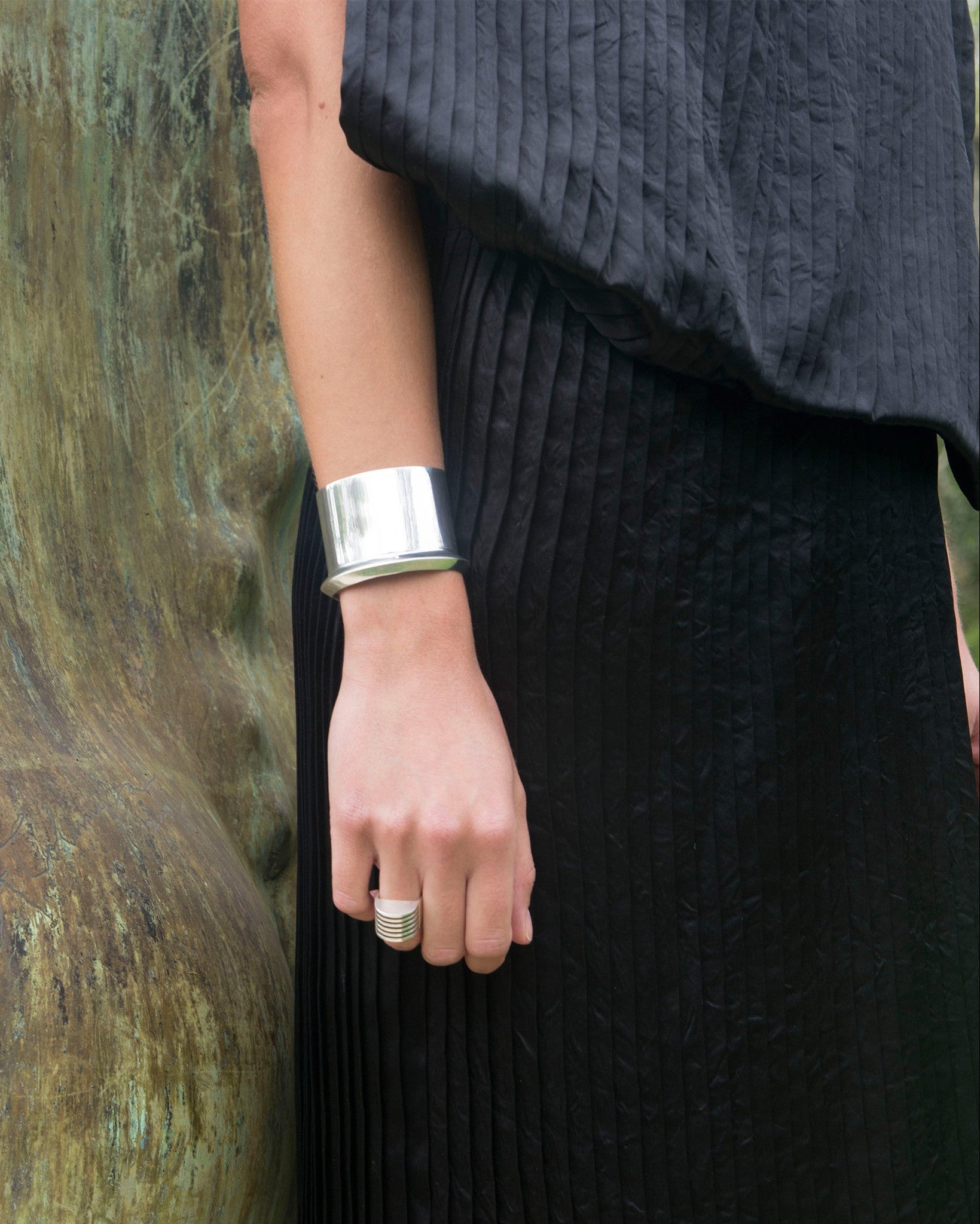 AGMES Cliff_Cuff Simple and modern cuff with a geometric scallop detail on one edge. Measures 1-7/8" wide, sterling silver.