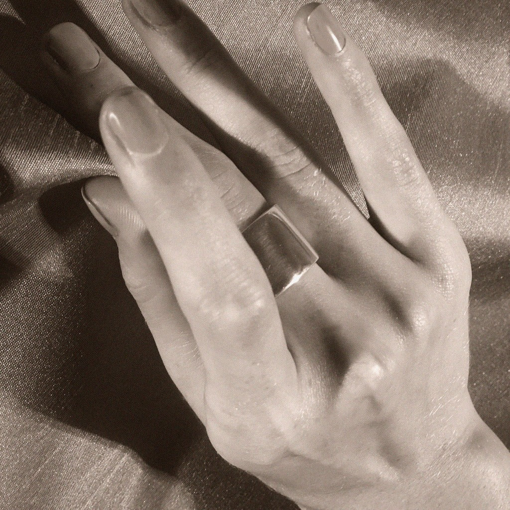 Hand wearing AGMES 0.925 Sterling Silver wide Daria Ring.