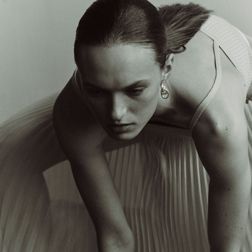 Woman wearing AGMES 0.925 sterling silver double drop hoop earrings.