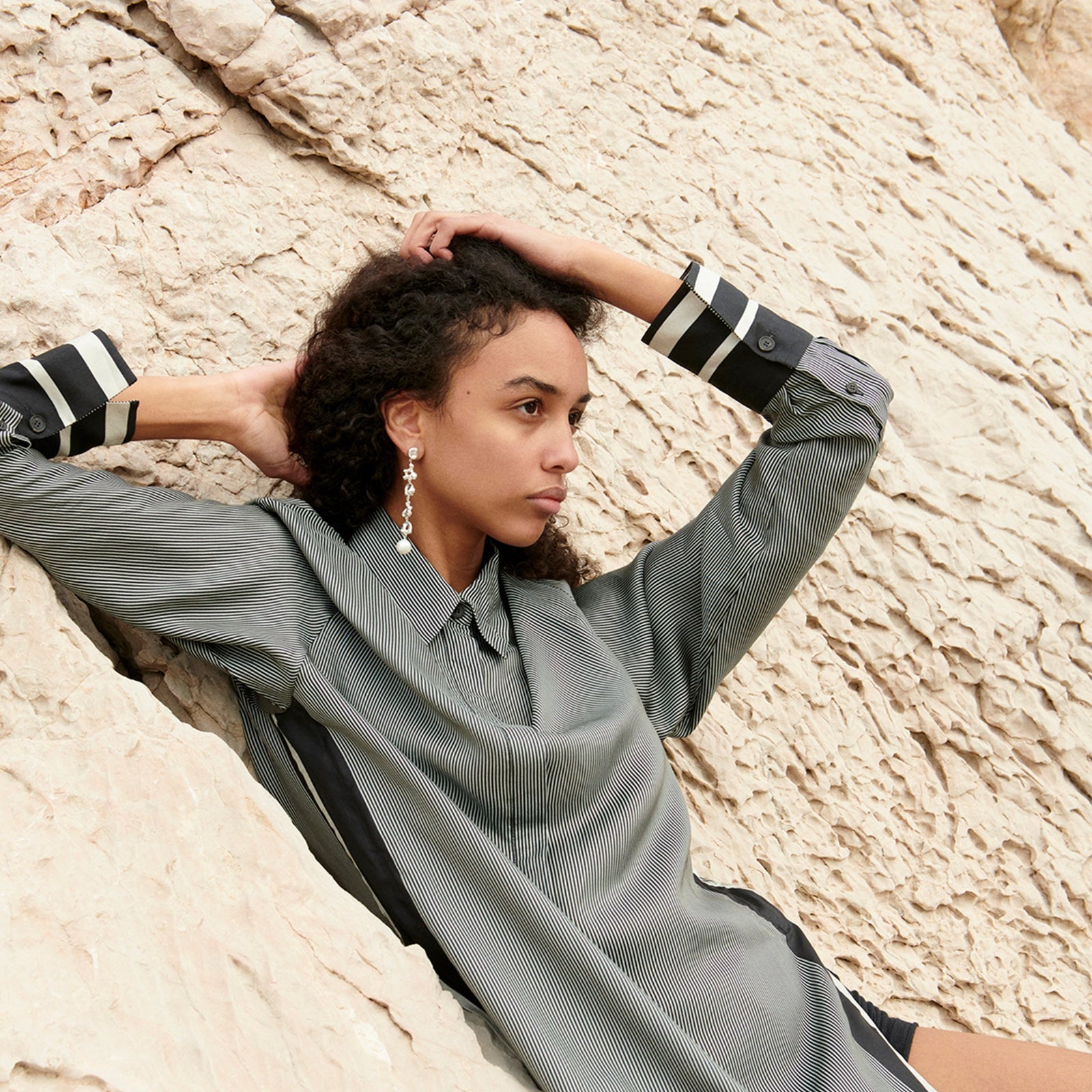 Woman wearing AGMES 0.925 sterling silver long Diane earrings with freshwater drop pearl. Simone Bodmer-Turner.