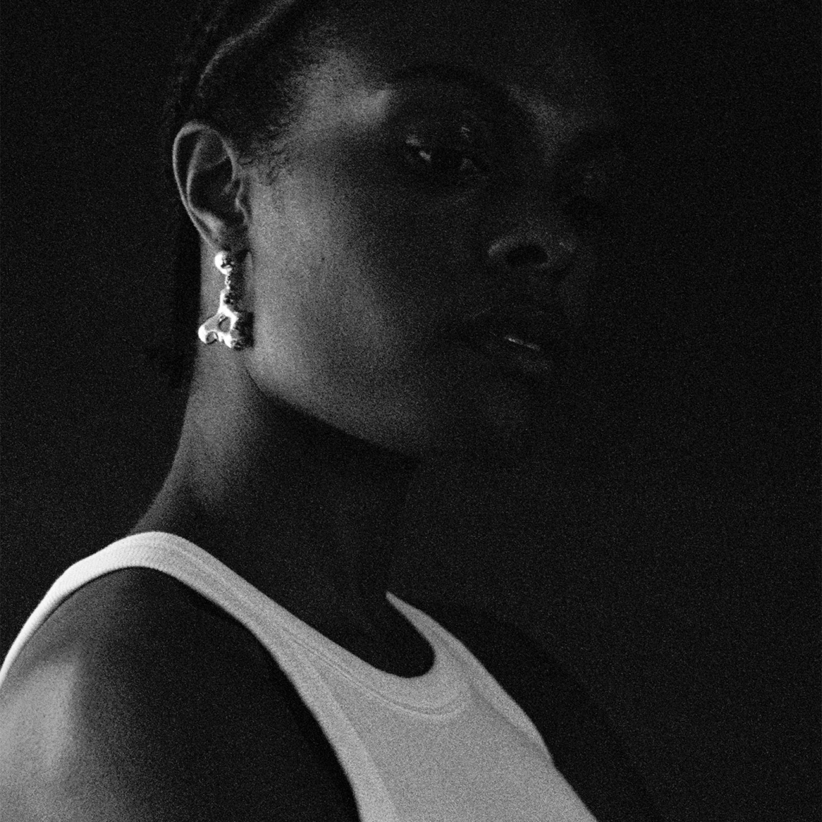 Woman wearing AGMES 0.925 sterling silver sculpted drop earrings. Simone Bodmer-Turner.