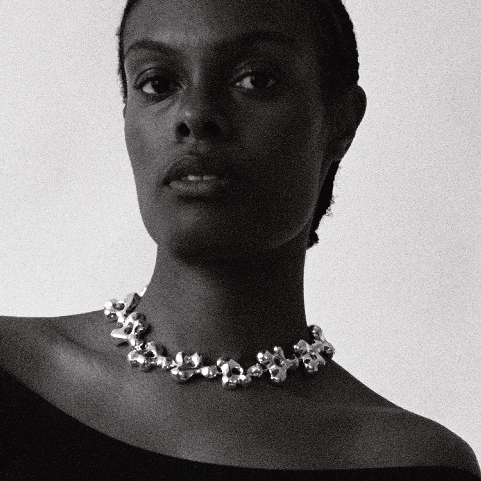 Model wearing AGMES .925 sterling silver sculptural collar Simone Necklace with black top.