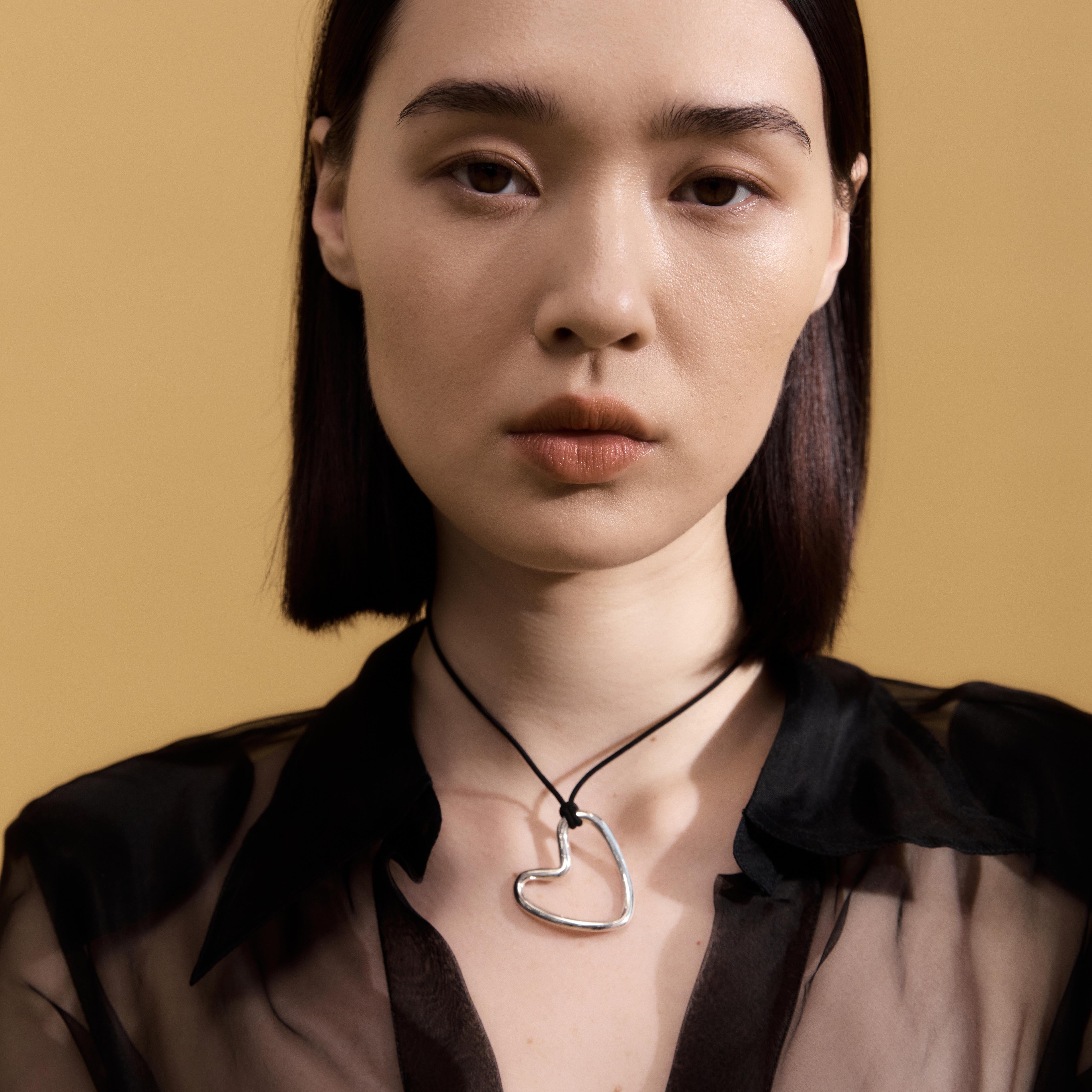 Woman wearing AGMES 0.925 sterling silver Altun Pendant with Black Suede Cord 