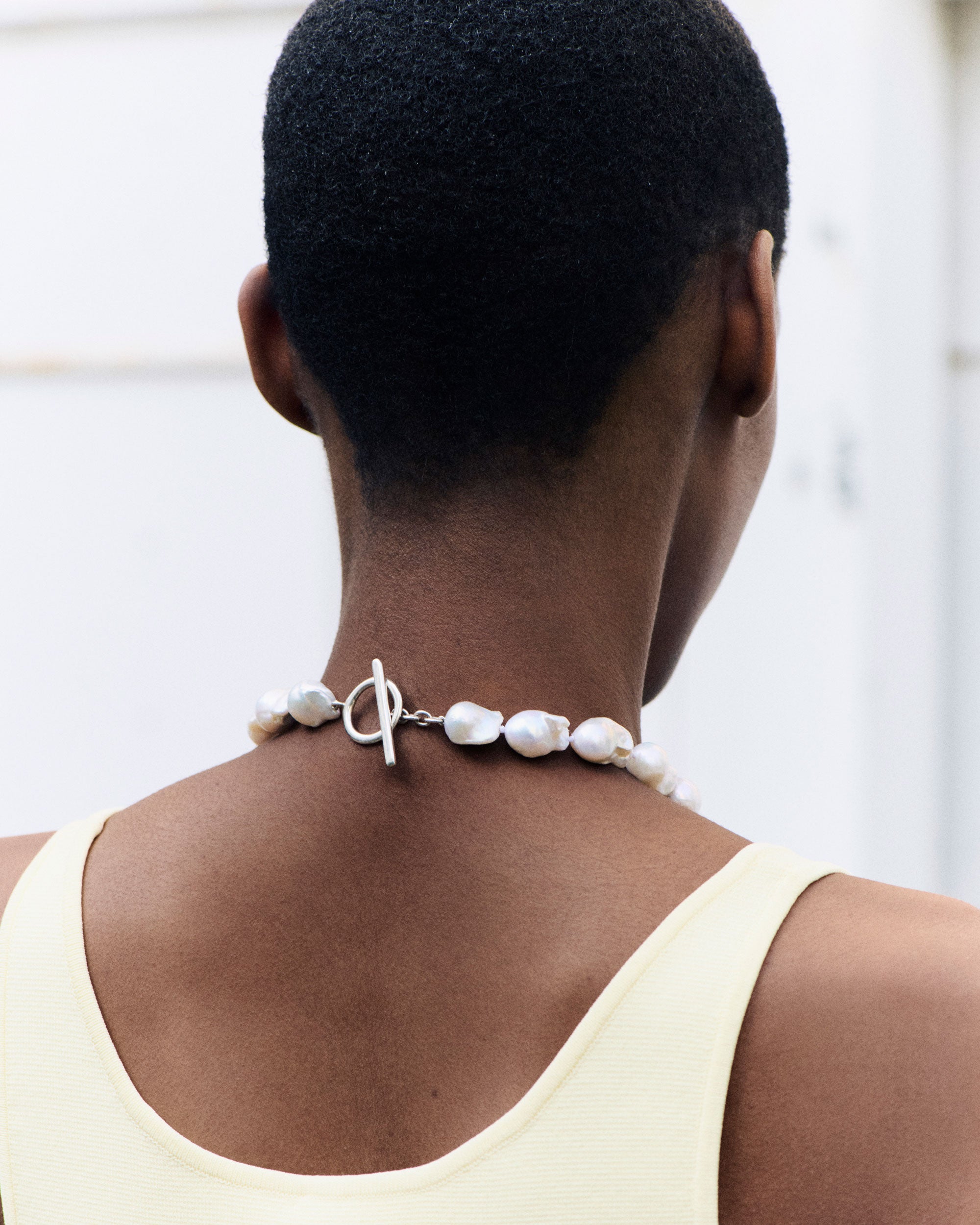 Model wearing AGMES Baroque Pearl collar Necklace with T-bar class 