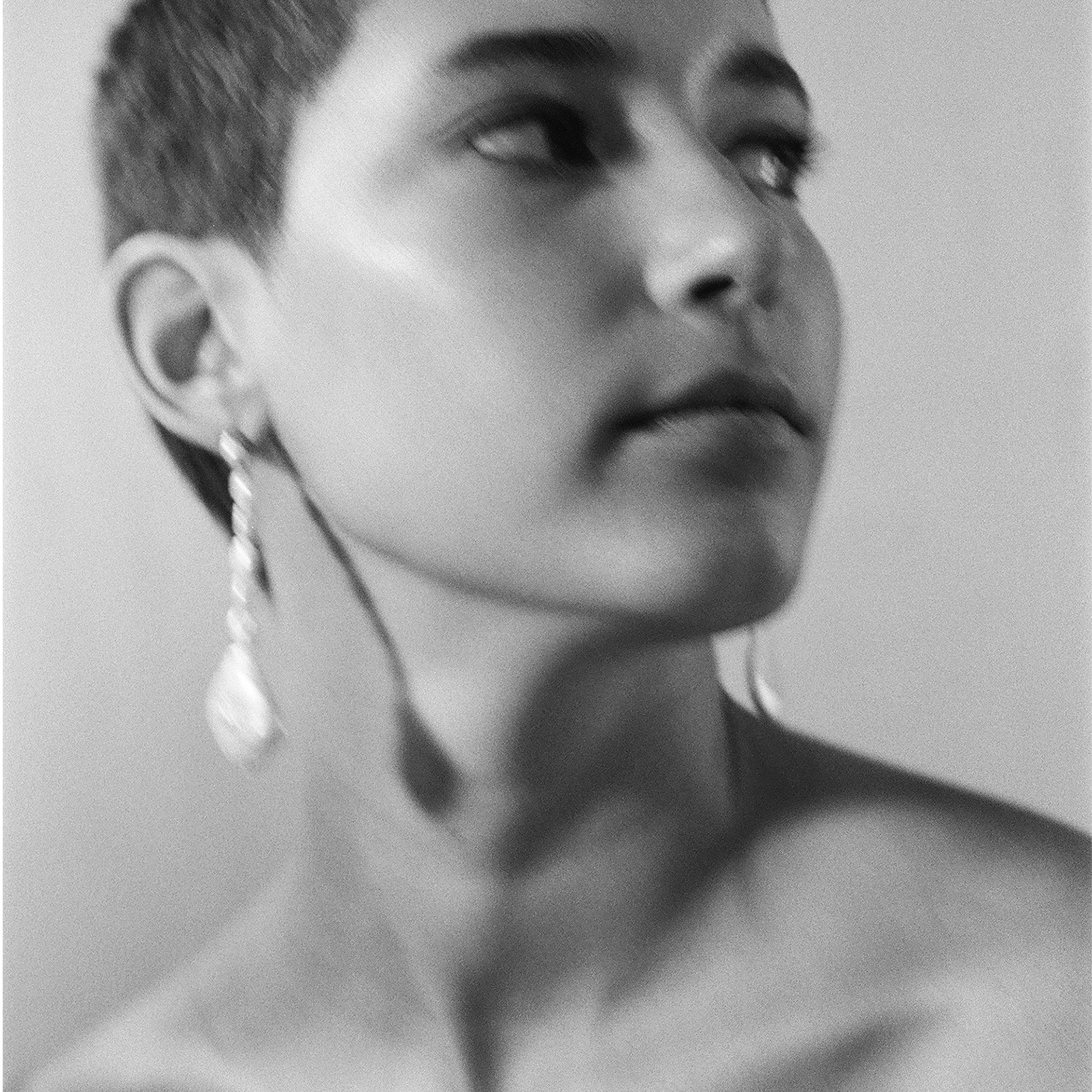 Woman wearing AGMES Emmanuelle earrings in 0.925 sterling silver with freshwater pearls.