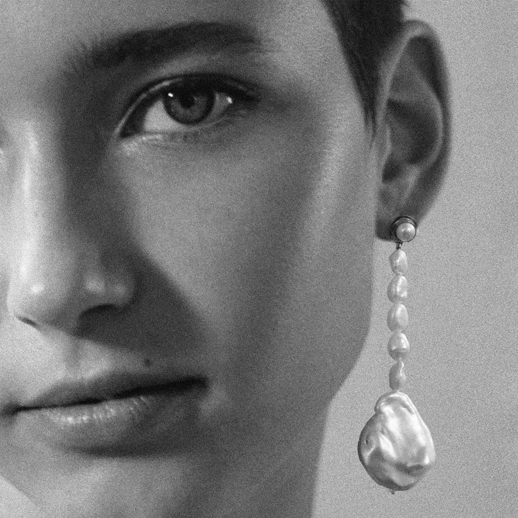 Woman wearing AGMES Emmanuelle earrings in 0.925 sterling silver with freshwater pearls.