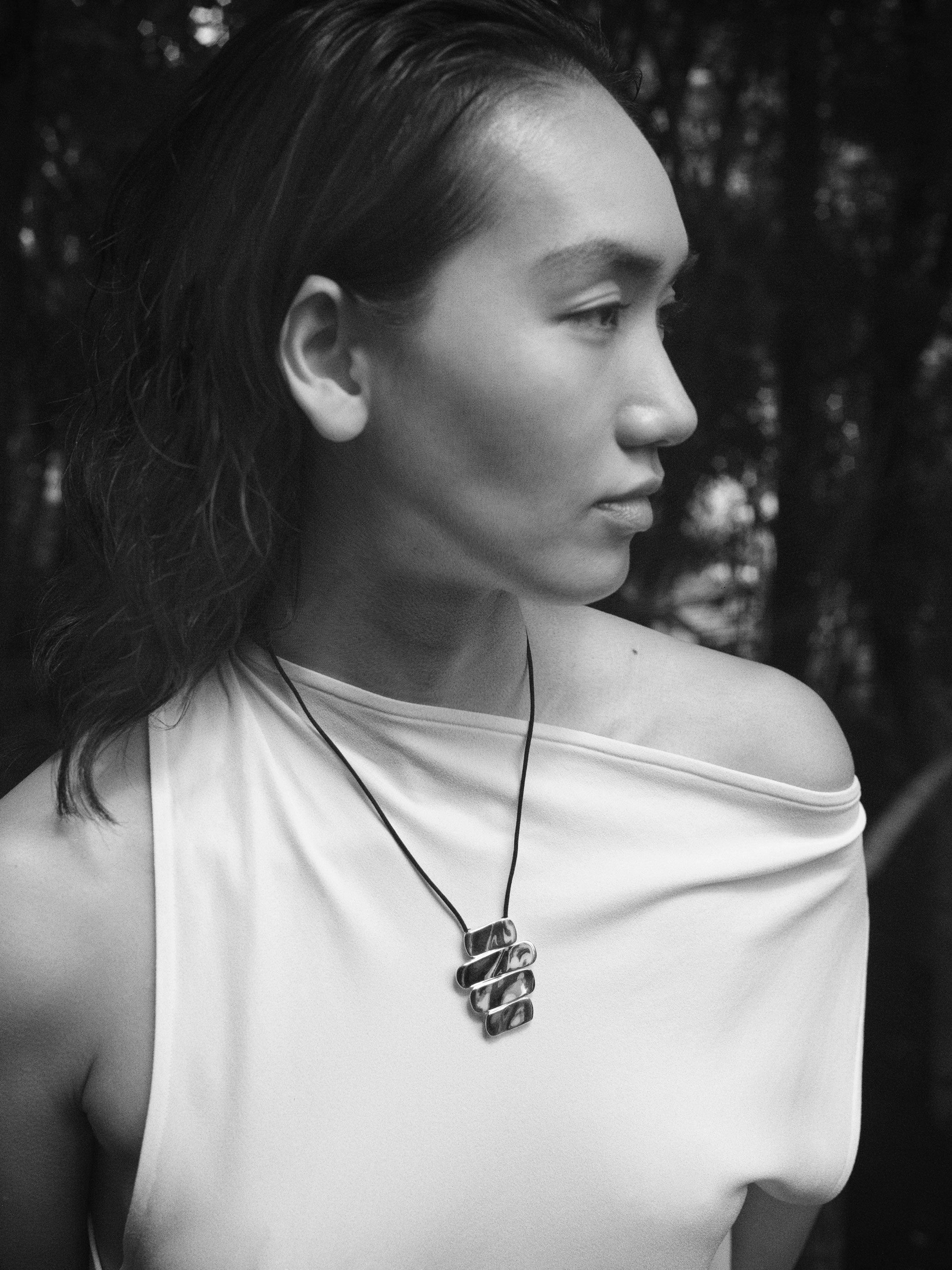 Women wearing AGMES 925 sterling silver 4-tier Ilona Pendant on black suede cord