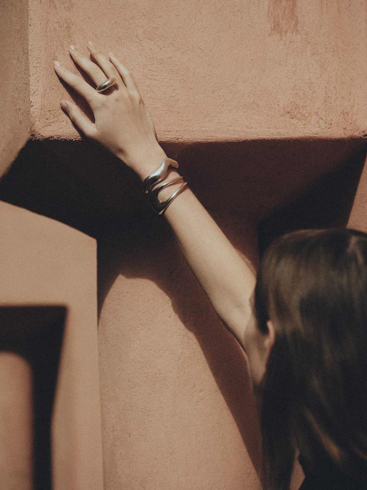 Woman wearing AGMES .925 Sterling Silver sculptural Jouve Ring on natural background. 