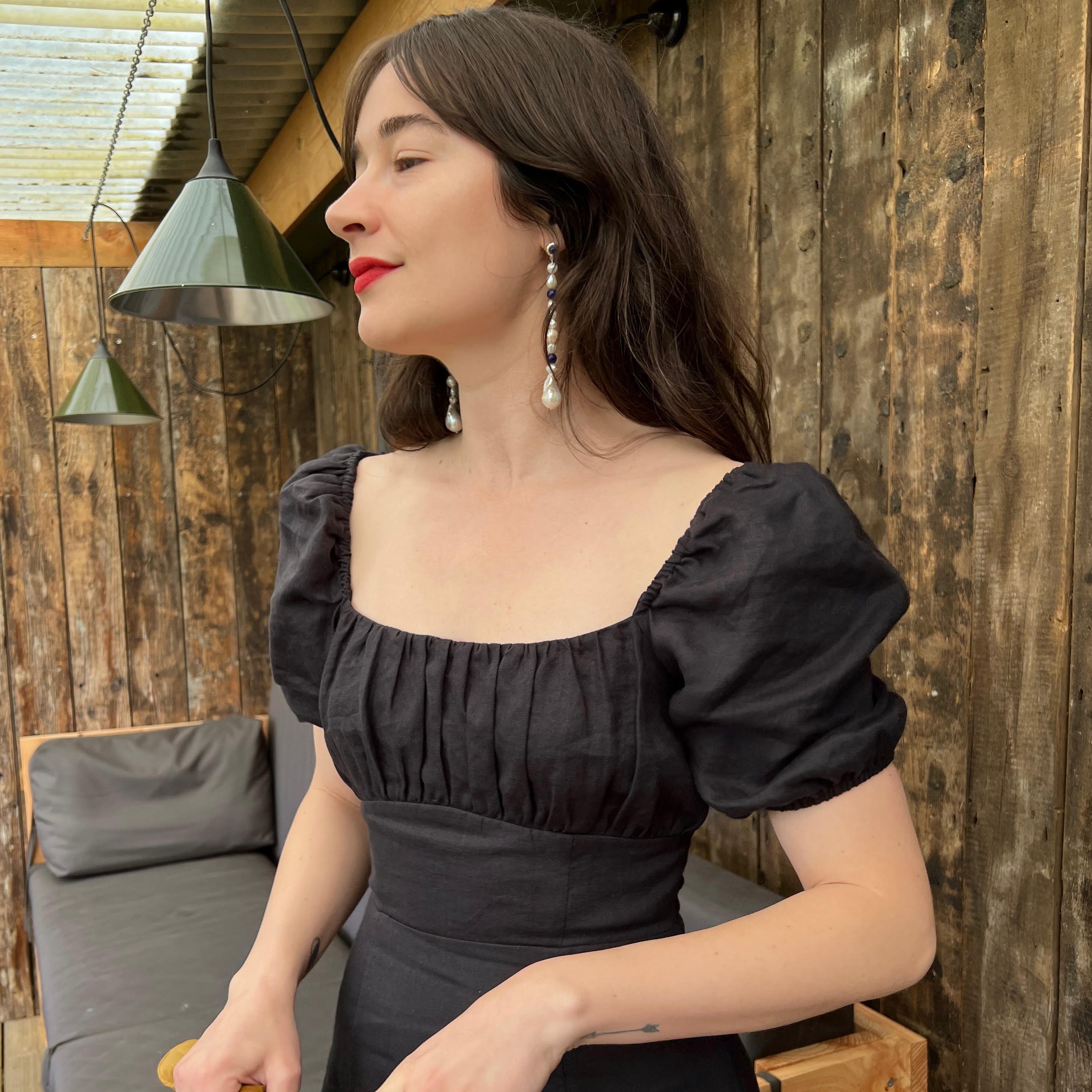 Woman wearing AGMES 18K Gold Vermeil Long Kait Earrings with Baroque Pearl and Lapis Stone. 