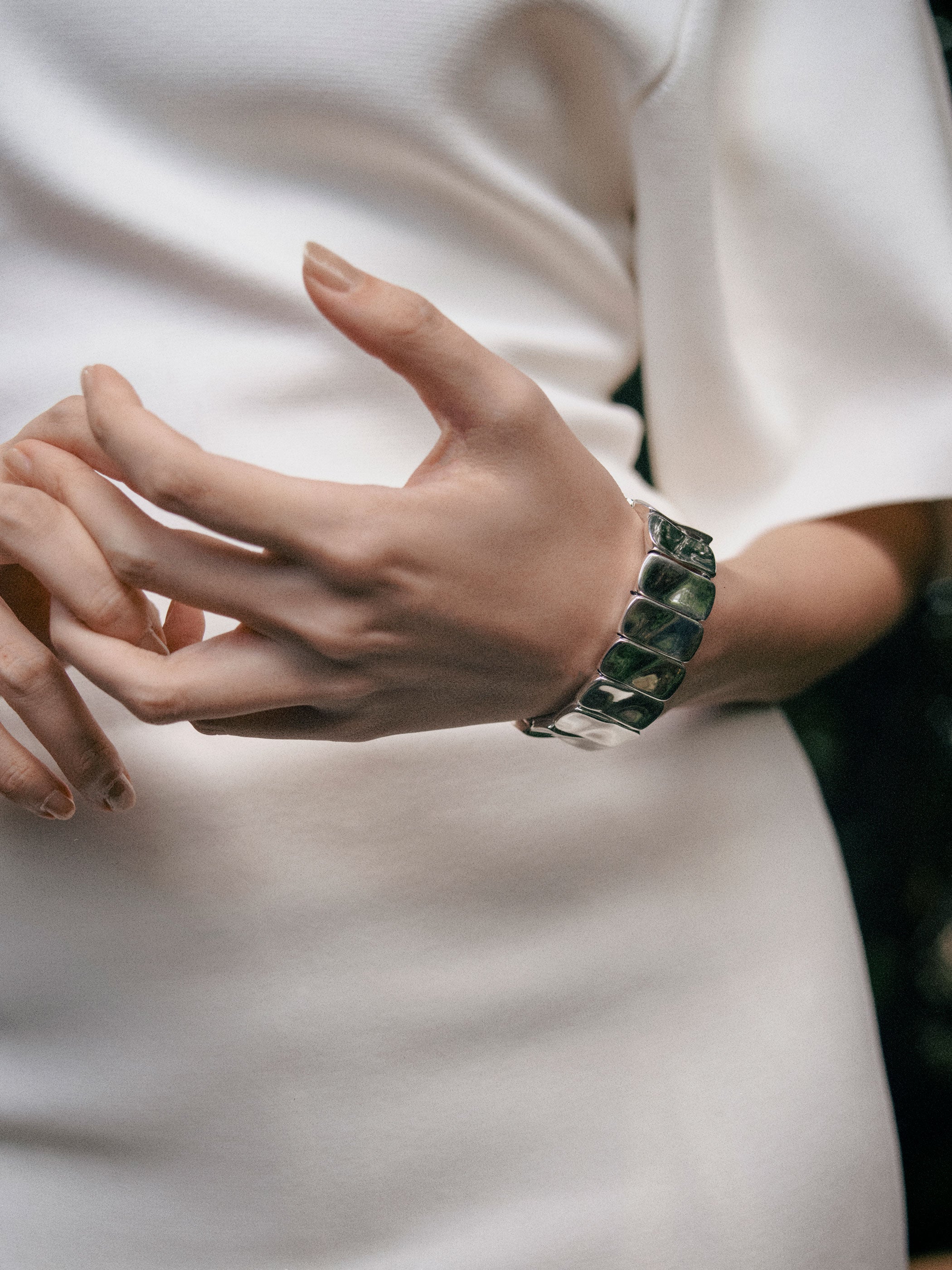 Person wearing AGMES .925 sterling silver sculptural Short Ilona Bracelet.