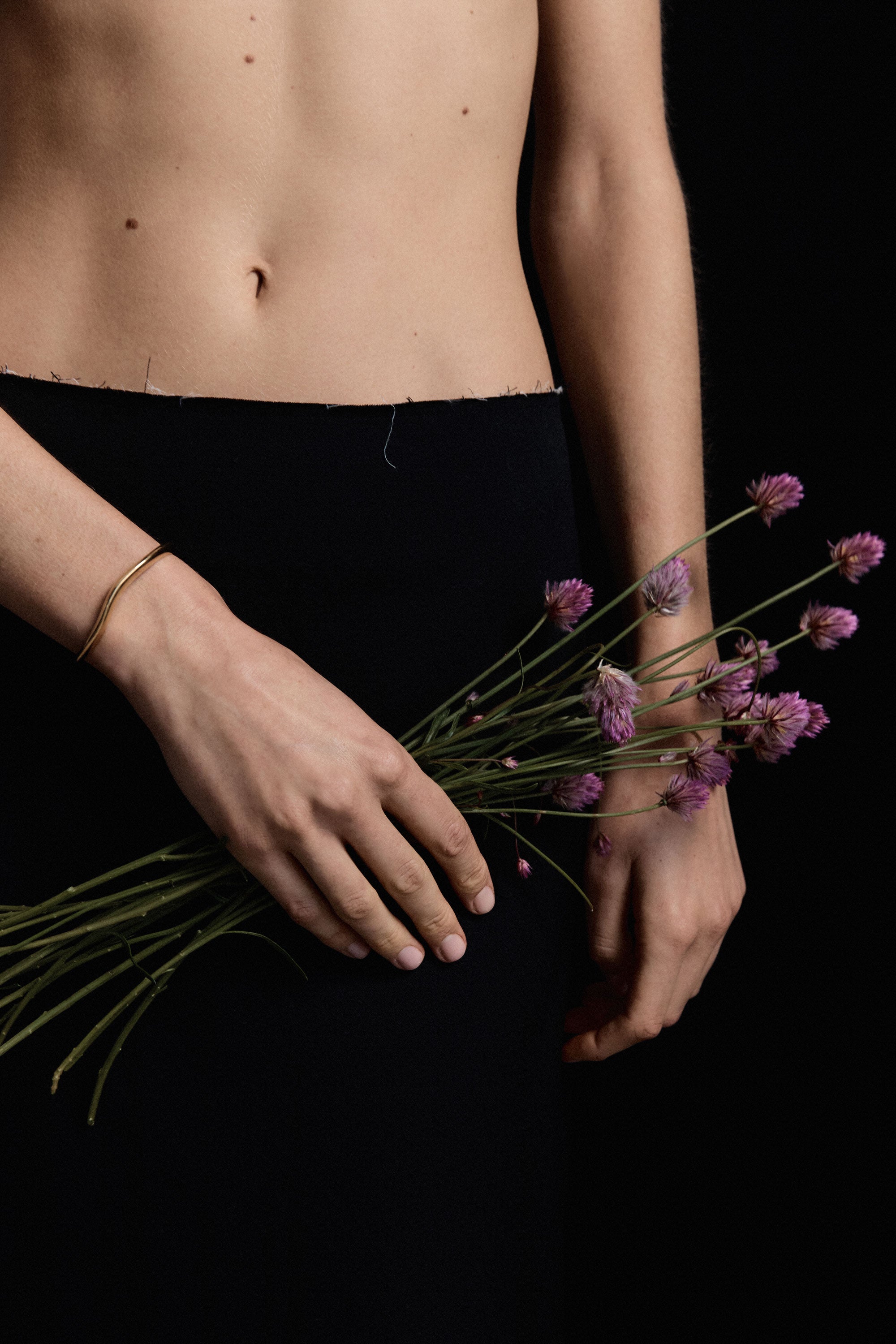 Person wearing AGMES 18k gold vermeil small thin sculpted cuff bracelet.