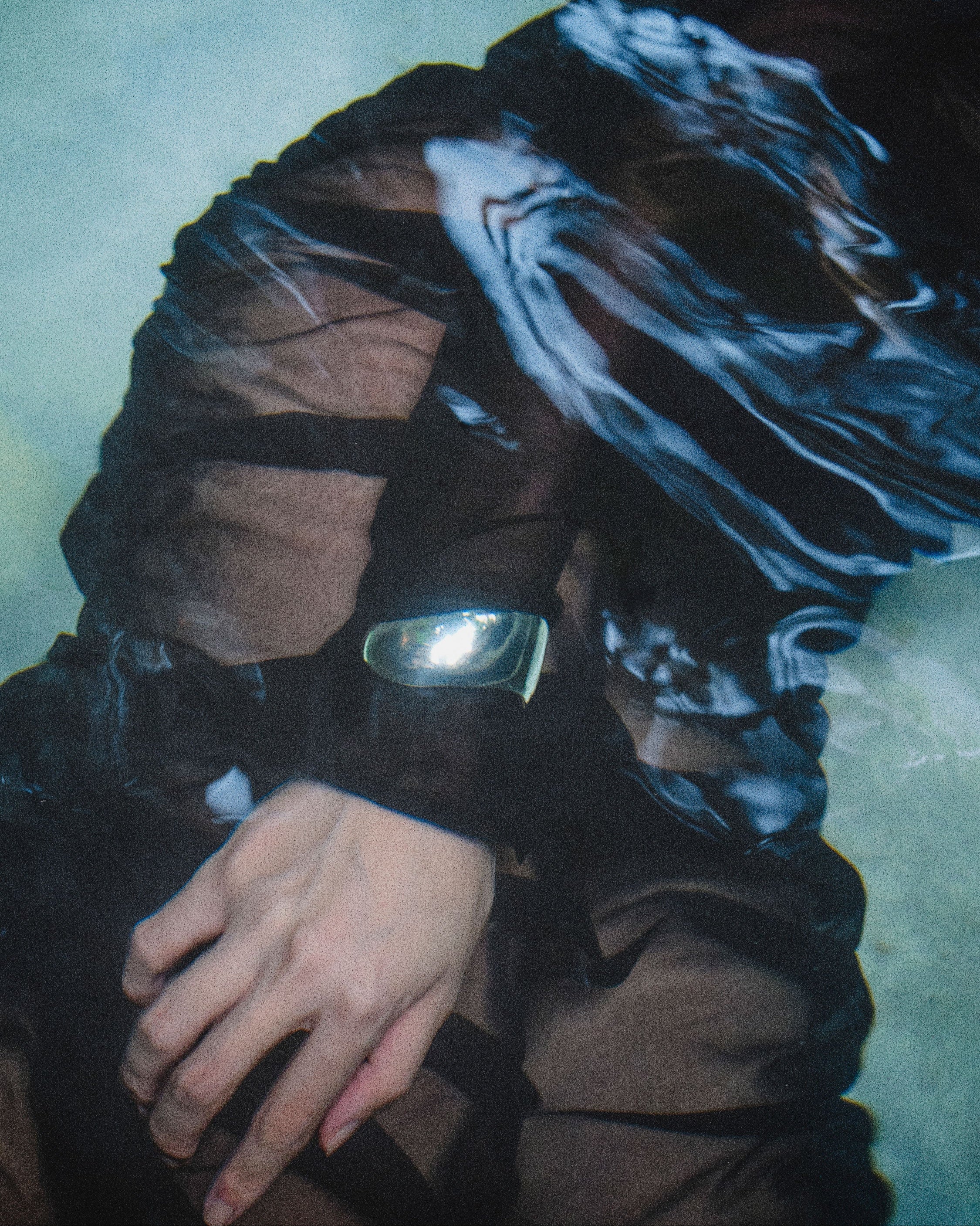 Person underwater in black dress and AGMES 0.925 sterling silver sculpted Cecil cuff bracelet.