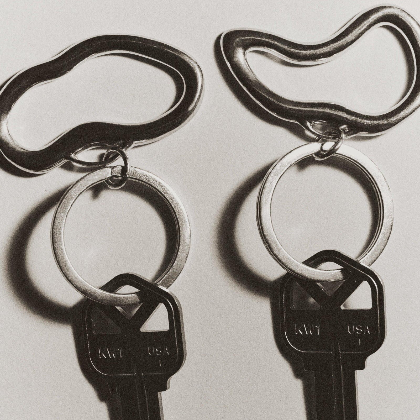 AGMES .925 sterling silver sculptural heart Sum of Parts Key Chain set on white background.