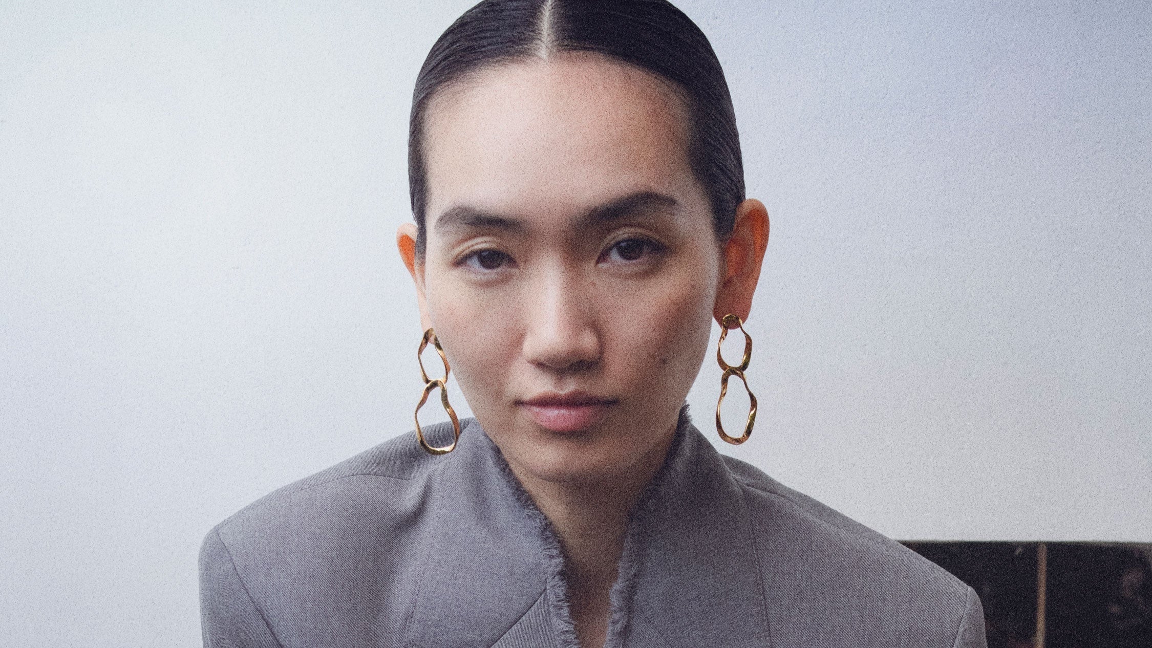 Woman wearing AGMES 18k gold vermeil Viviane Earrings with tiered hoop design.