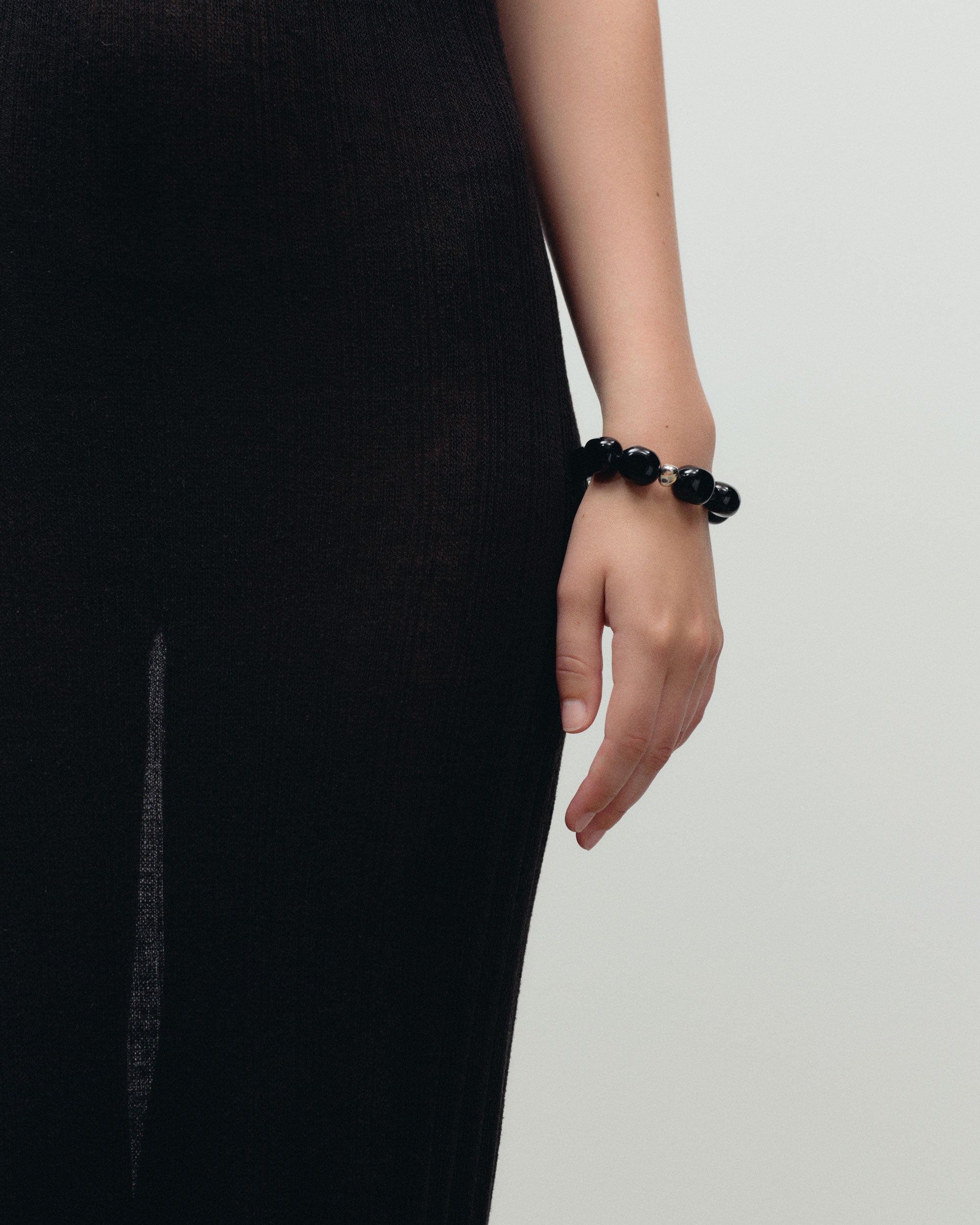 Black onyx beaded bracelet with .925 sterling silver accent on models wrist