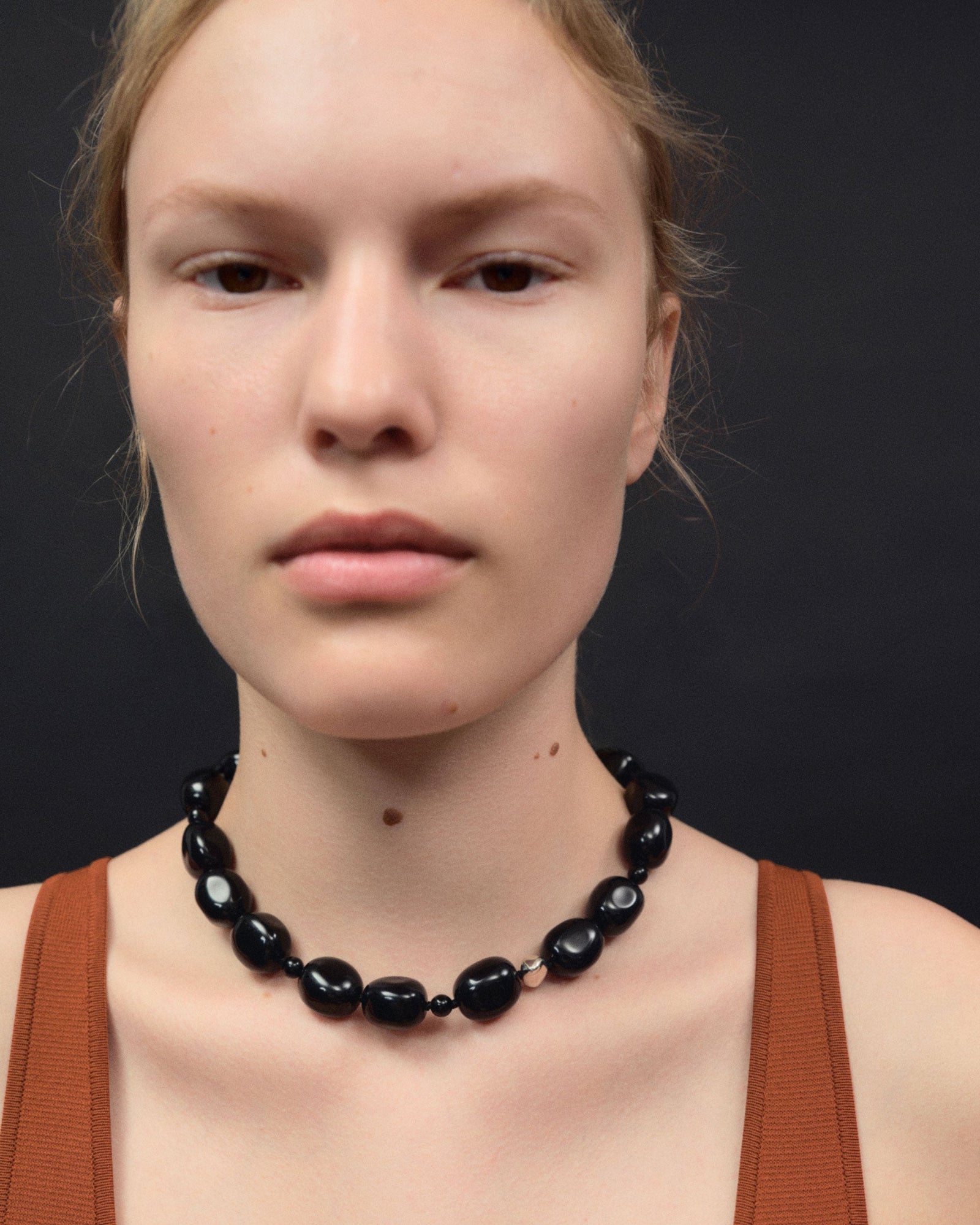 Black onyx beaded necklace with .925 sterling silver accent on woman's neck